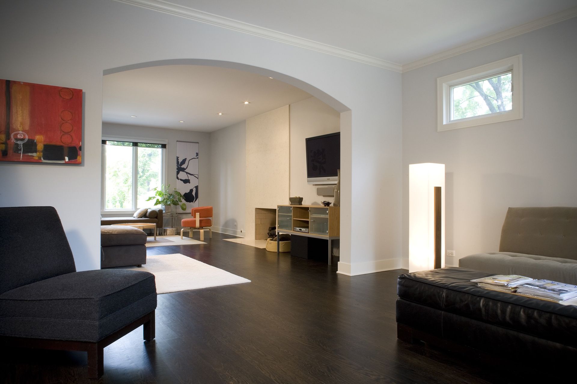 A living room with a couch ottoman and chairs