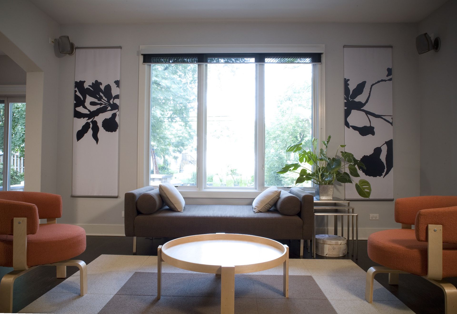 A living room with a couch and two chairs