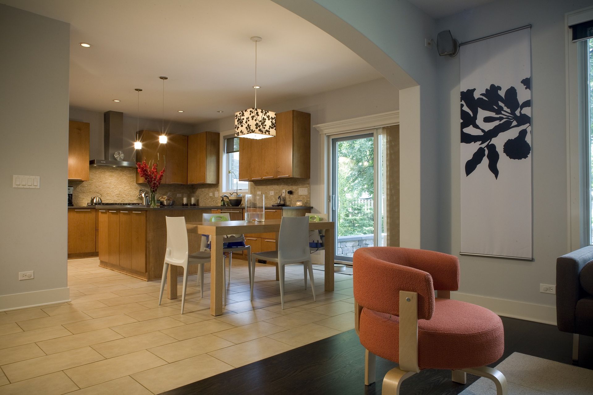A living room with a table and chairs and a painting on the wall