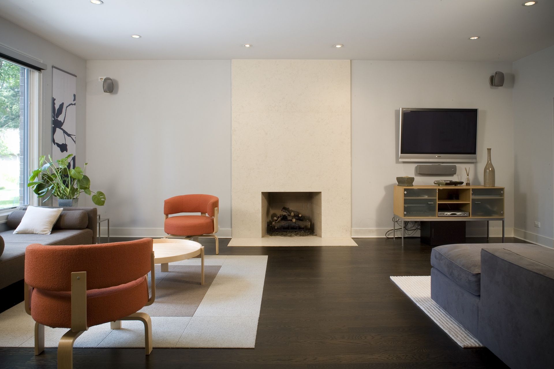 A living room with a fireplace and a flat screen tv