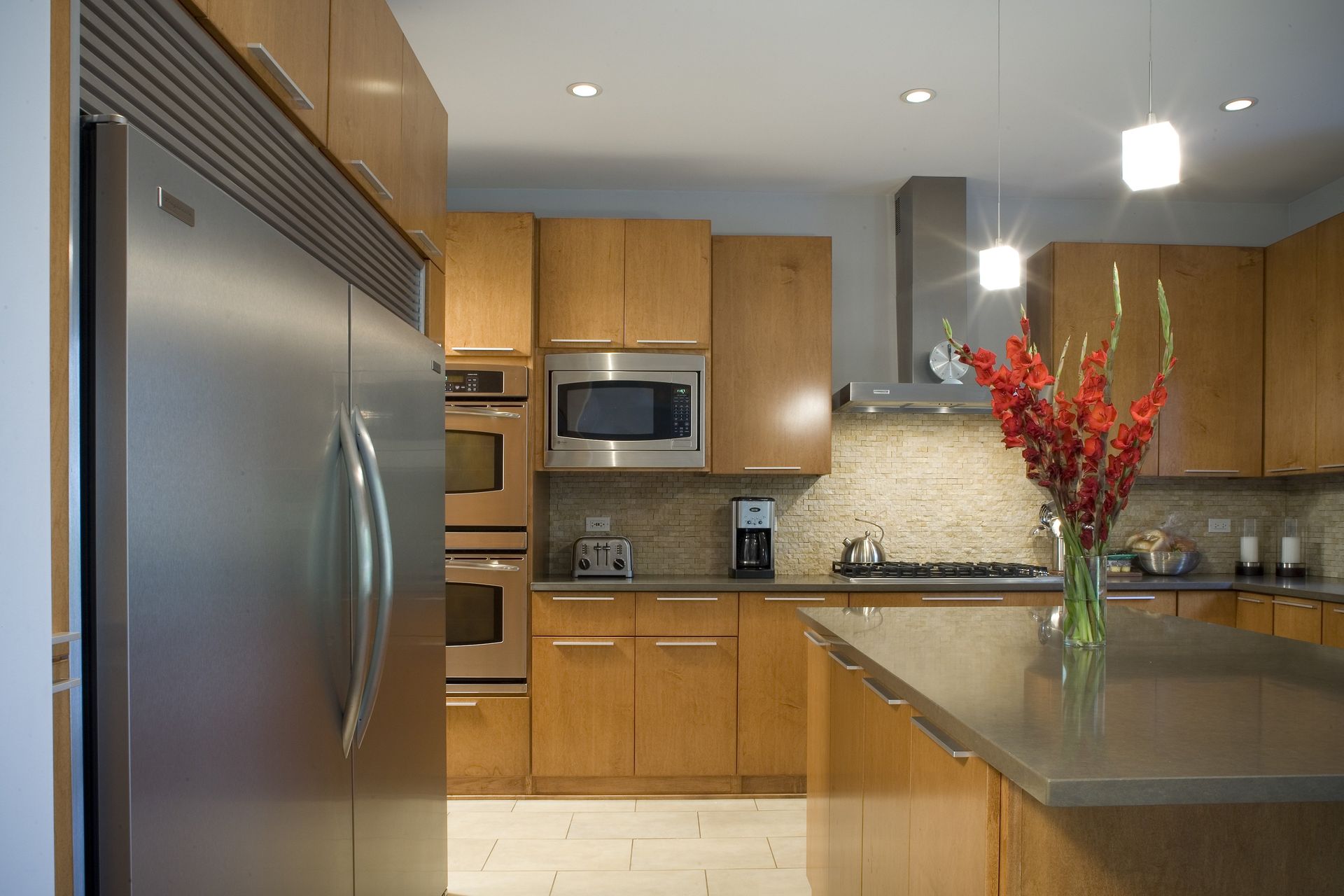 A kitchen with stainless steel appliances and wooden cabinets