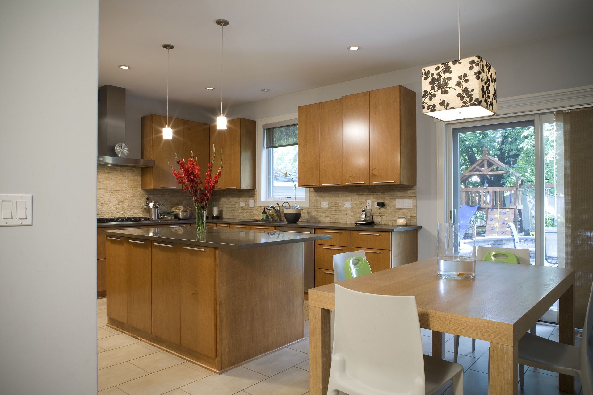 A kitchen with wooden cabinets and a table and chairs