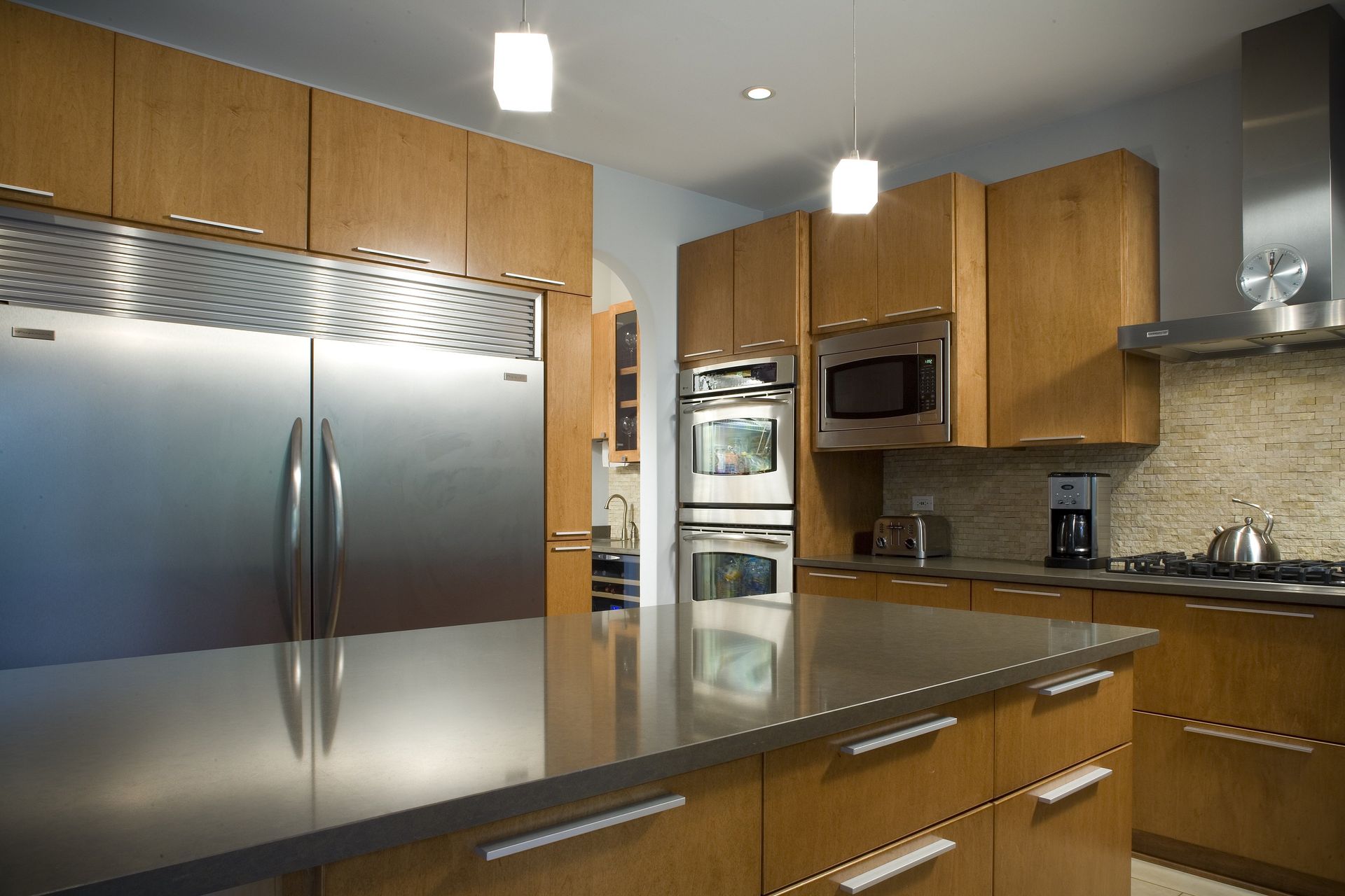 A kitchen with stainless steel appliances and wooden cabinets