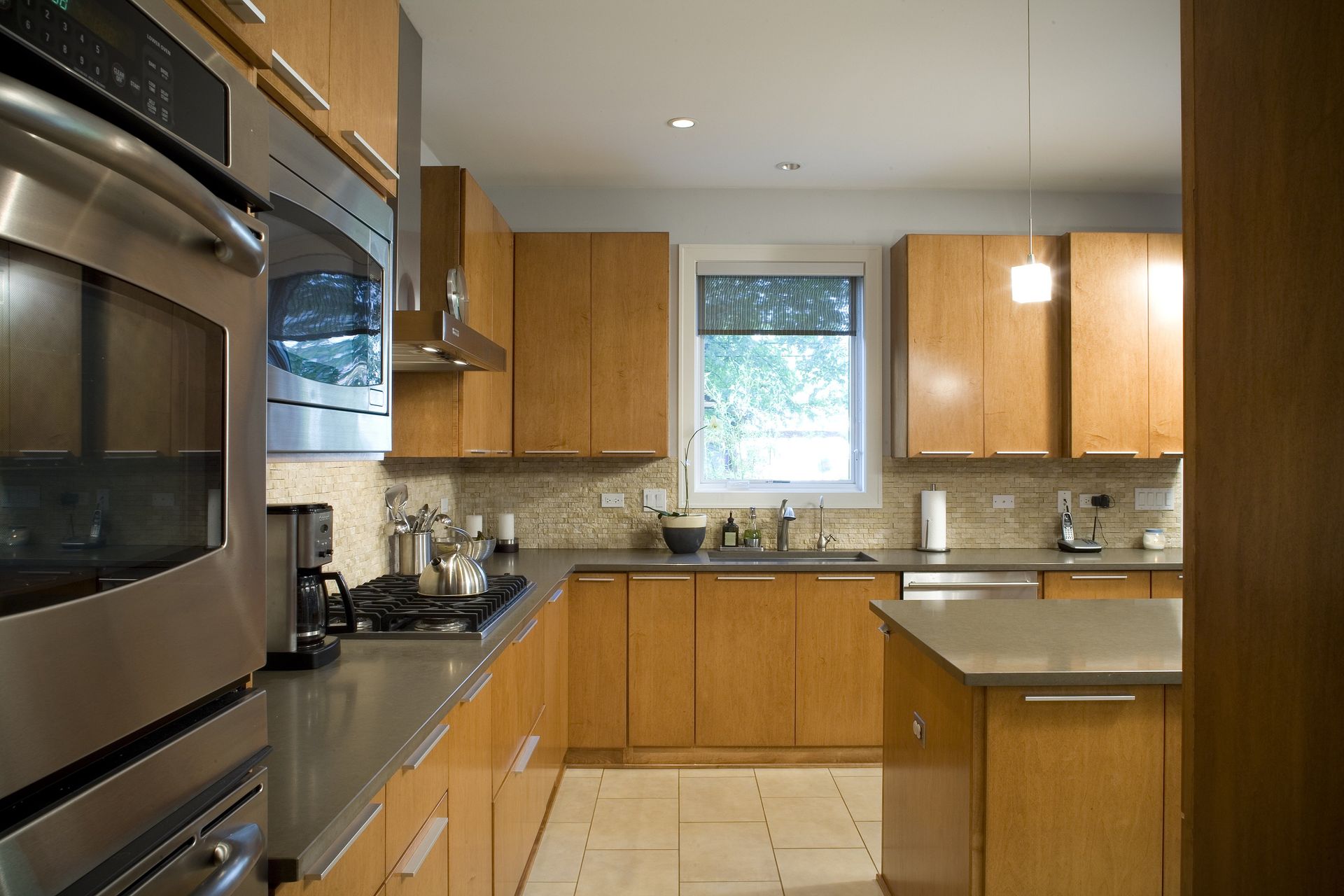 A kitchen with stainless steel appliances and wooden cabinets