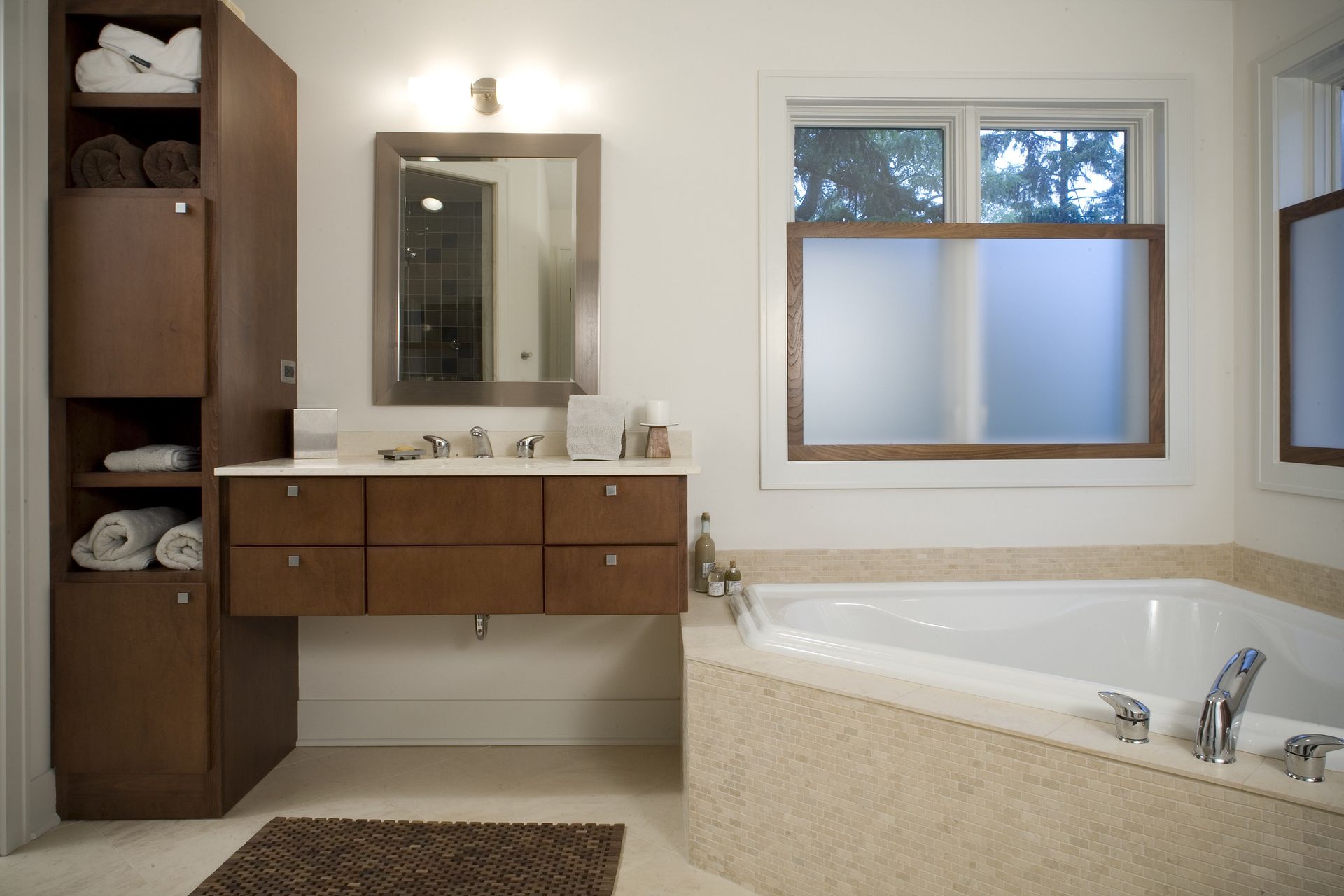 A bathroom with a tub a sink and a window