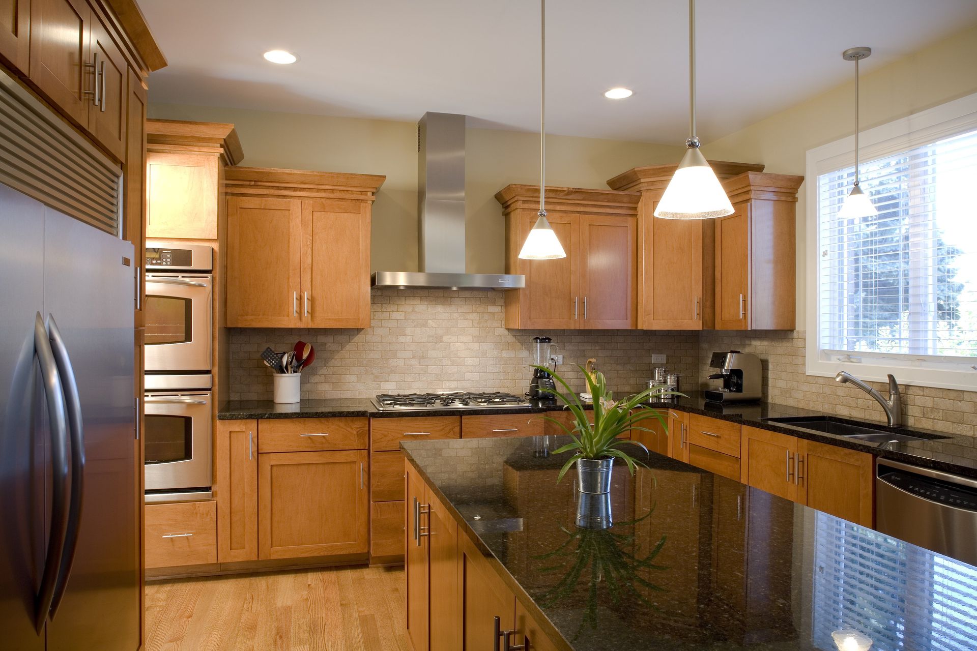 A kitchen with stainless steel appliances and wooden cabinets