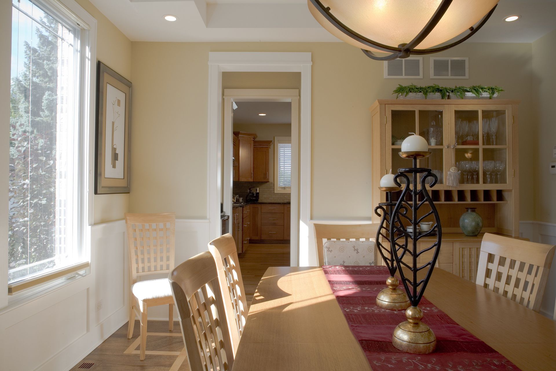 A dining room with a table and chairs and a chandelier