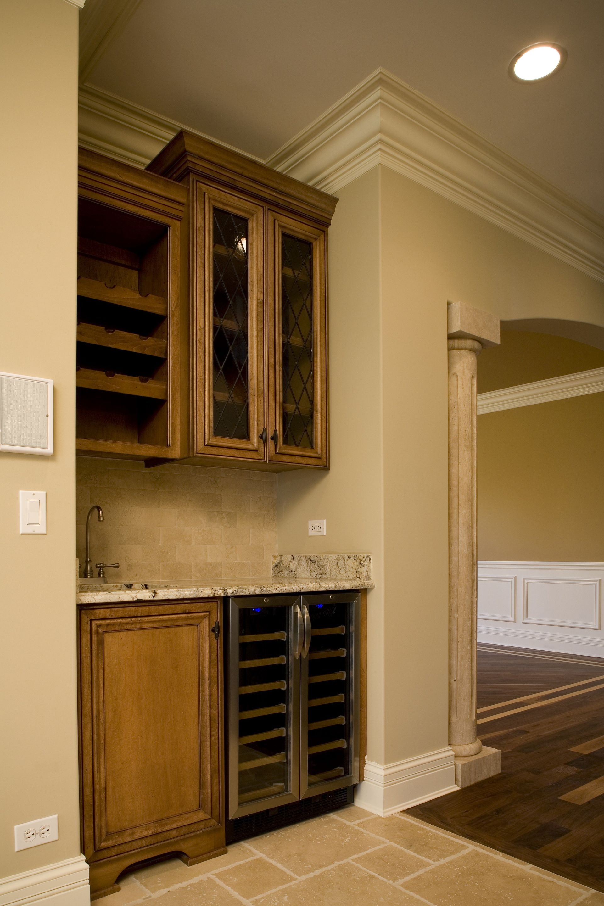 A kitchen with wooden cabinets and a wine cooler