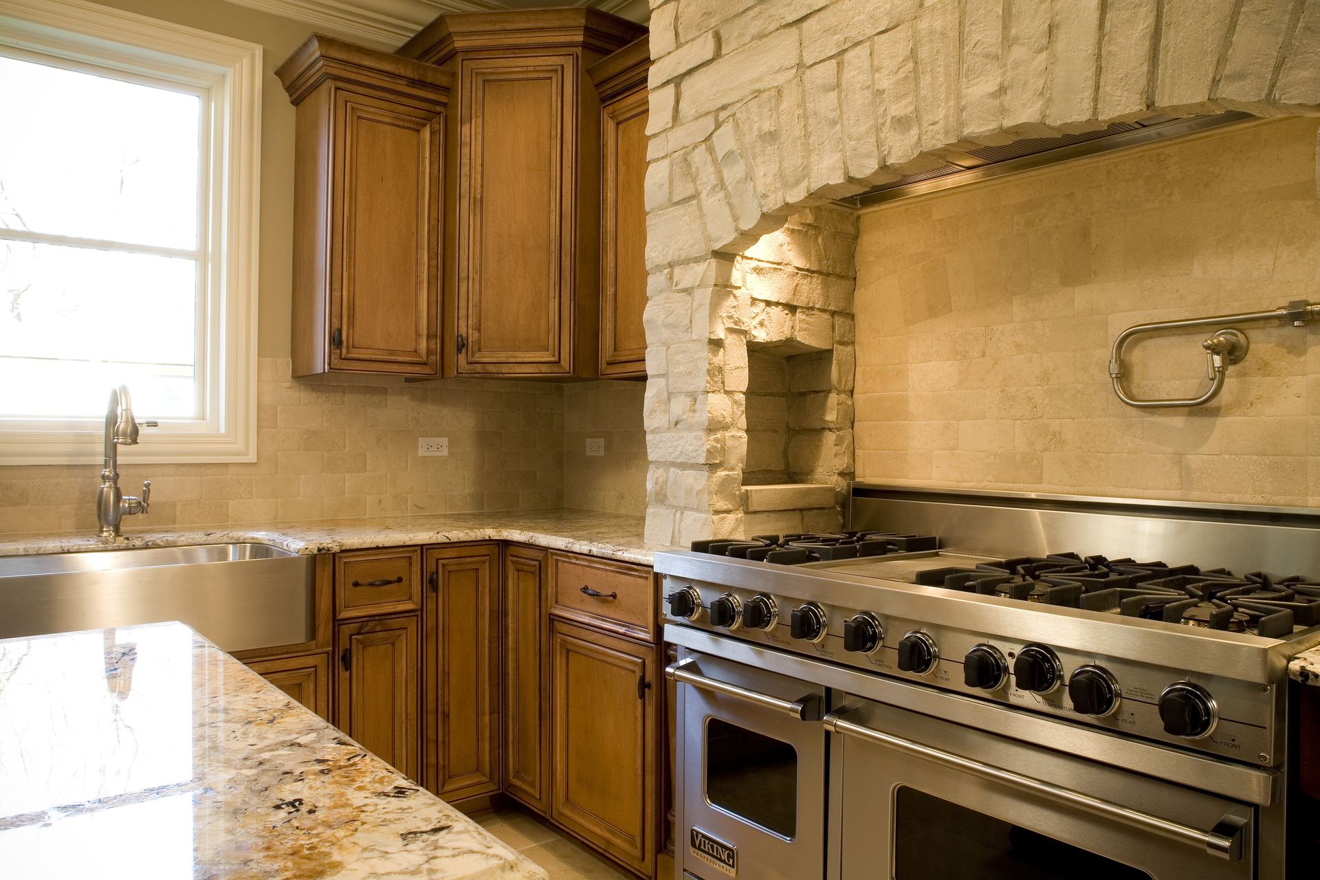 A kitchen with a stove top oven and a sink