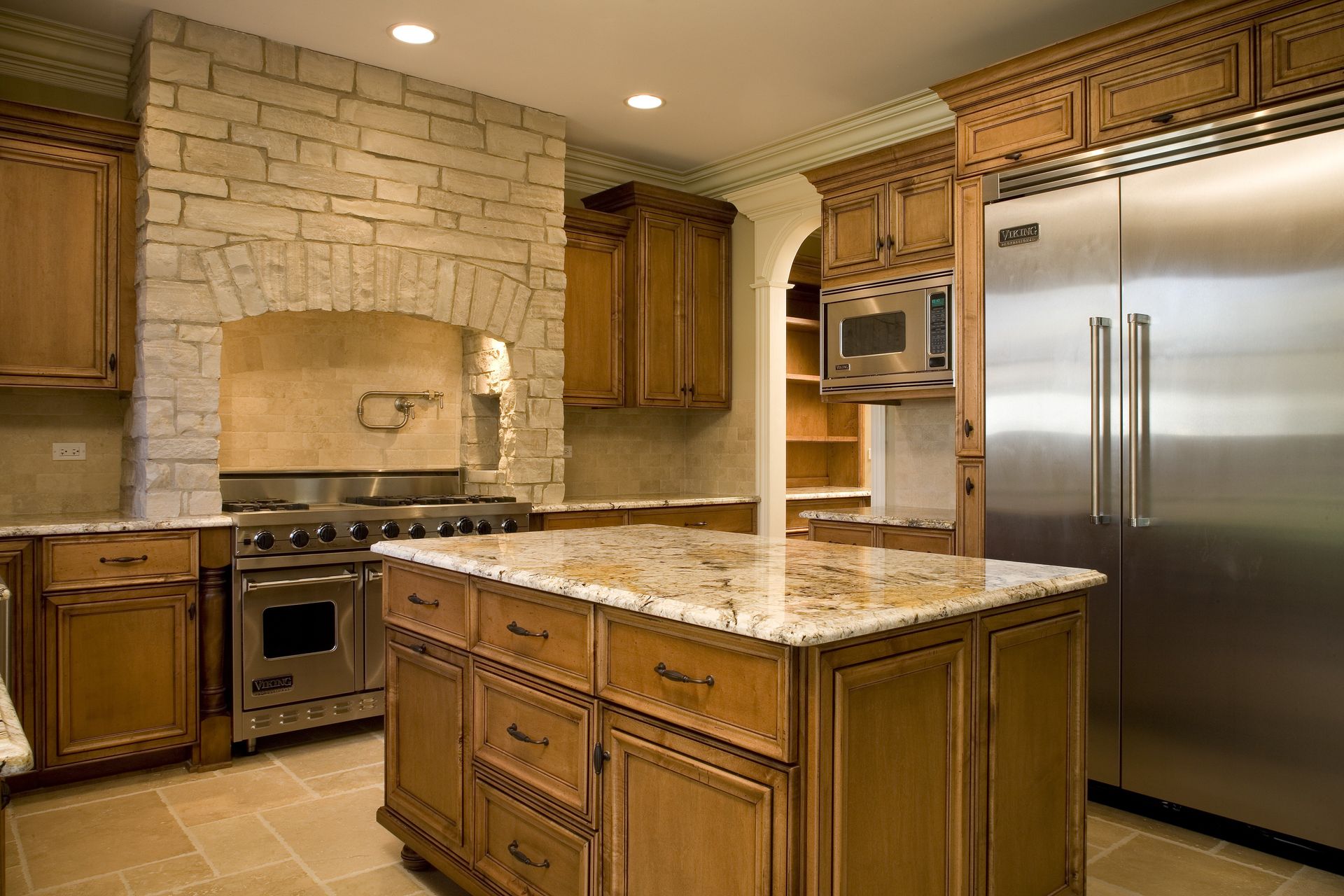 A kitchen with stainless steel appliances and wooden cabinets