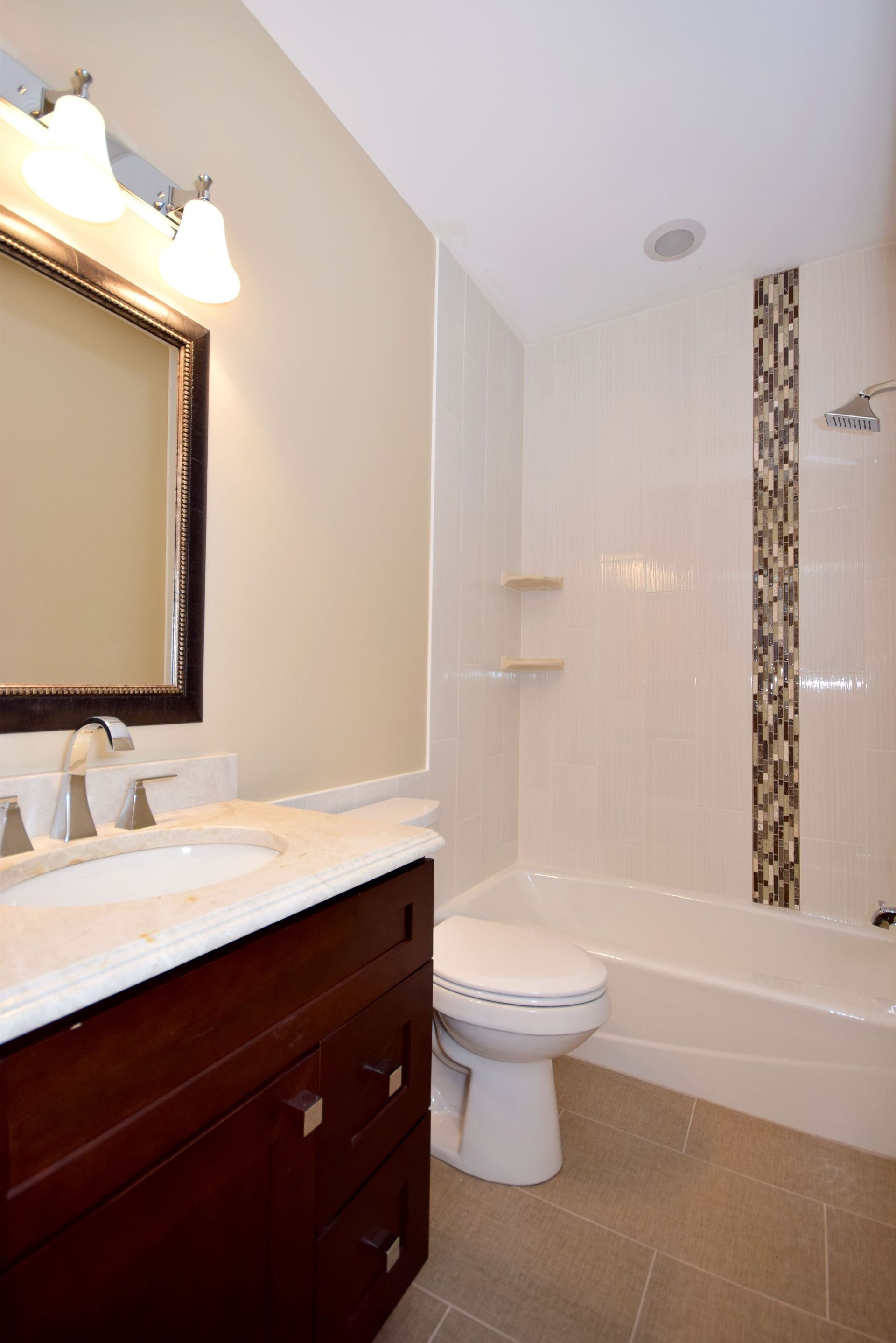 A bathroom with a toilet a sink and a mirror