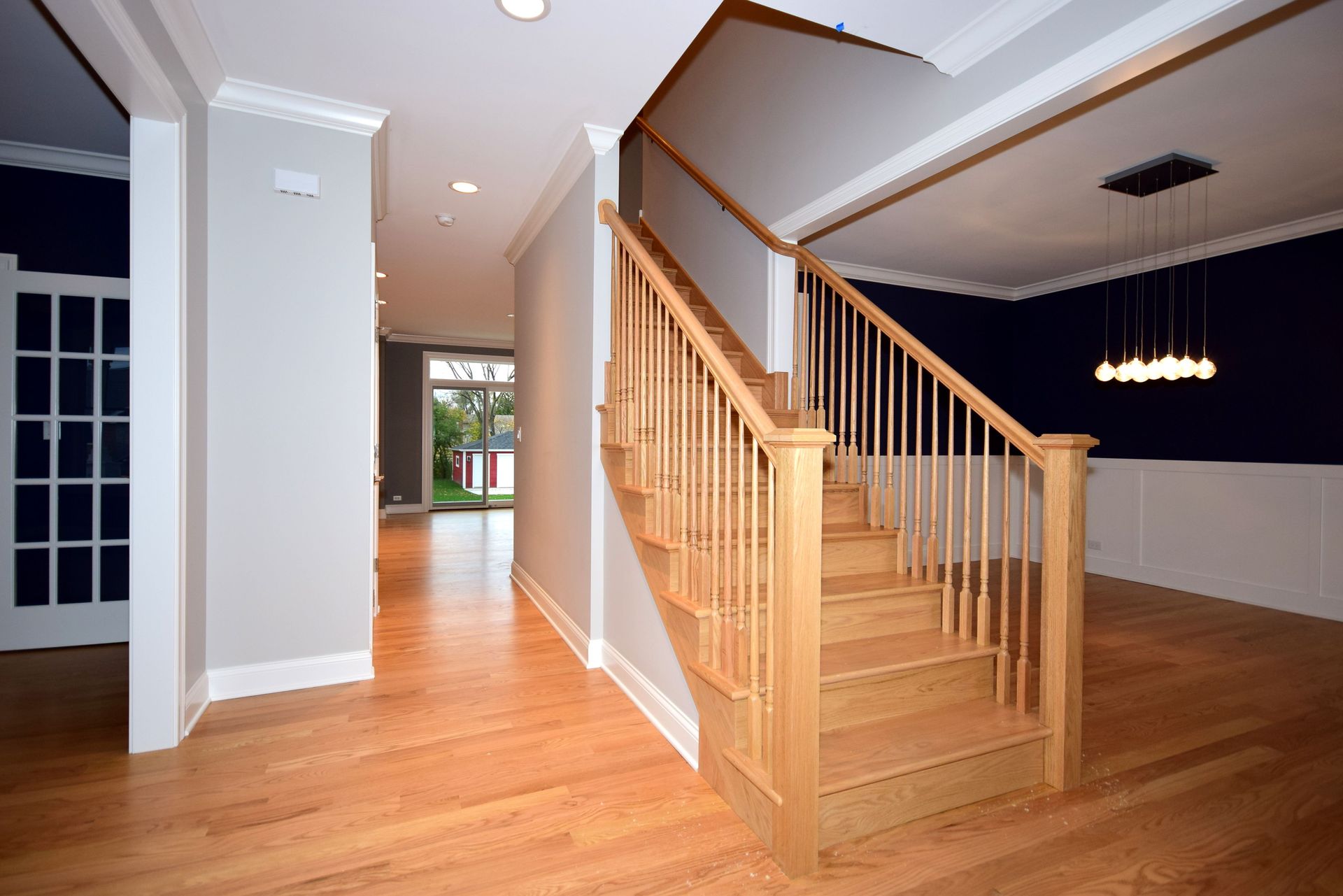 A wooden staircase leading up to the second floor of a house