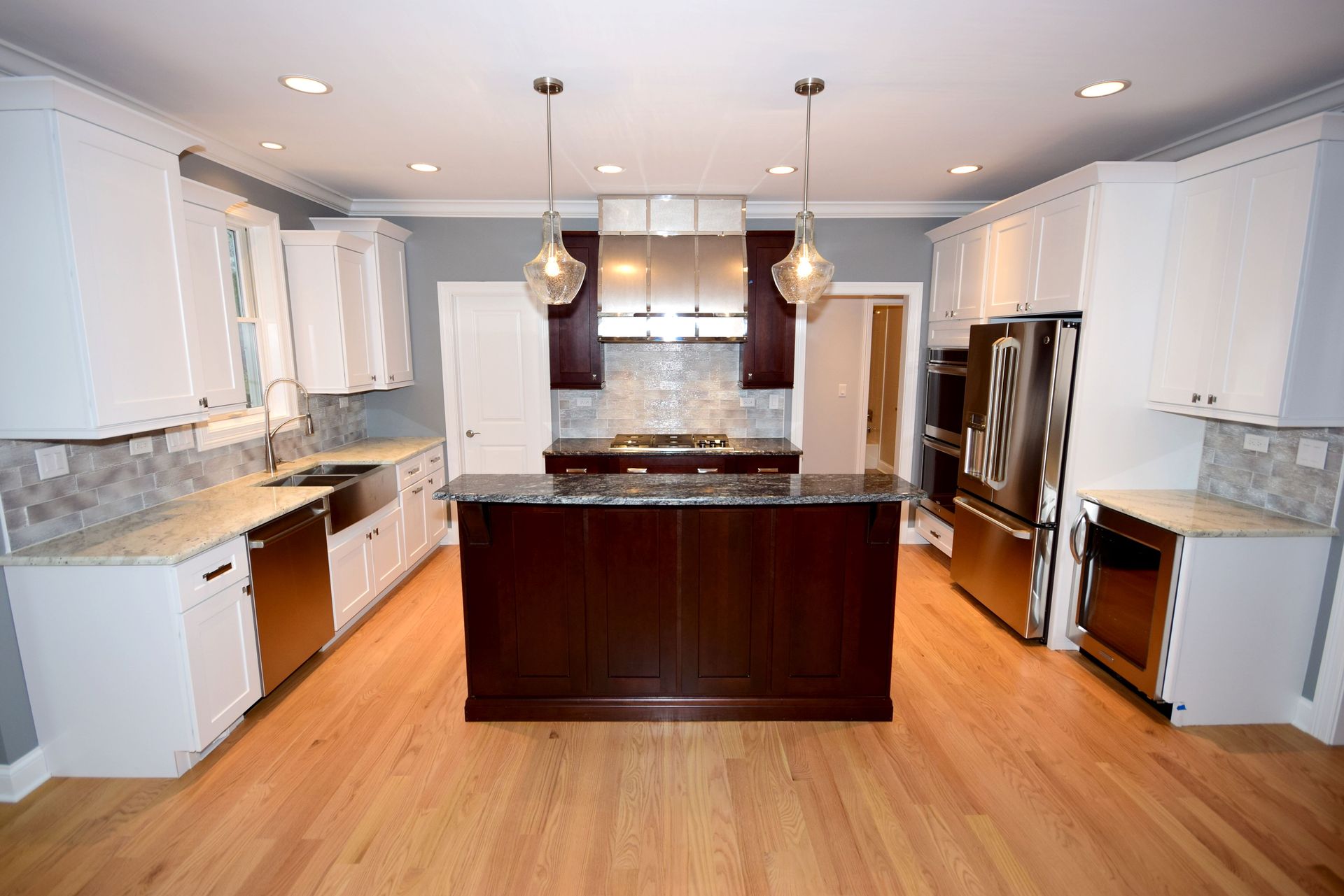 A kitchen with white cabinets and stainless steel appliances