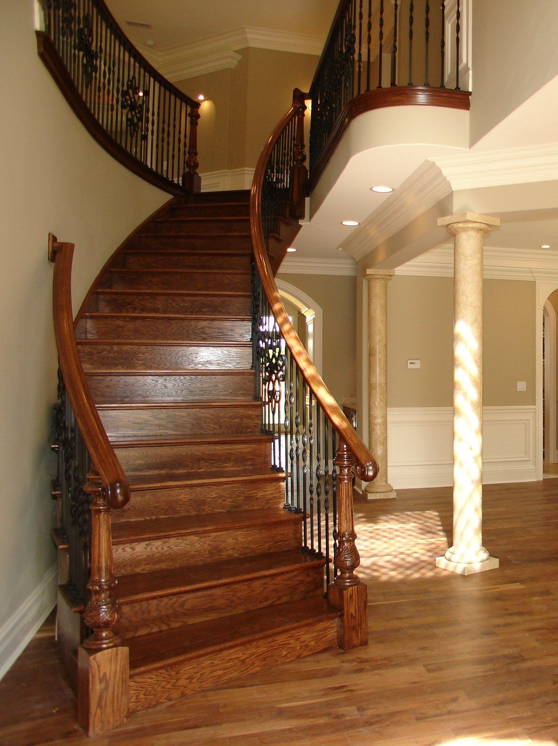 A wooden staircase with a metal railing in a house
