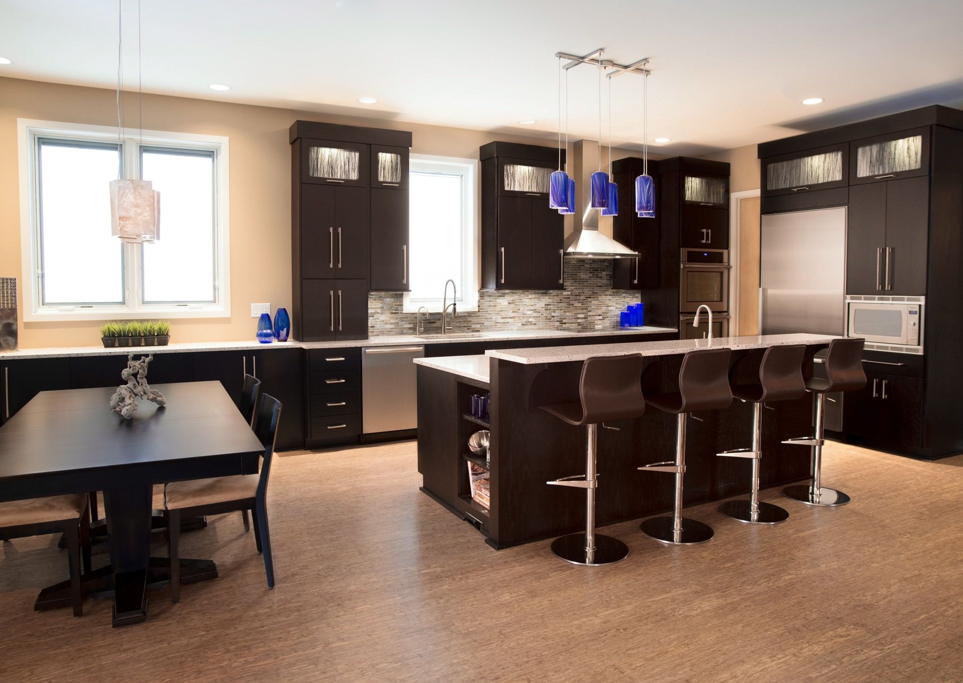 A kitchen with black cabinets and stainless steel appliances