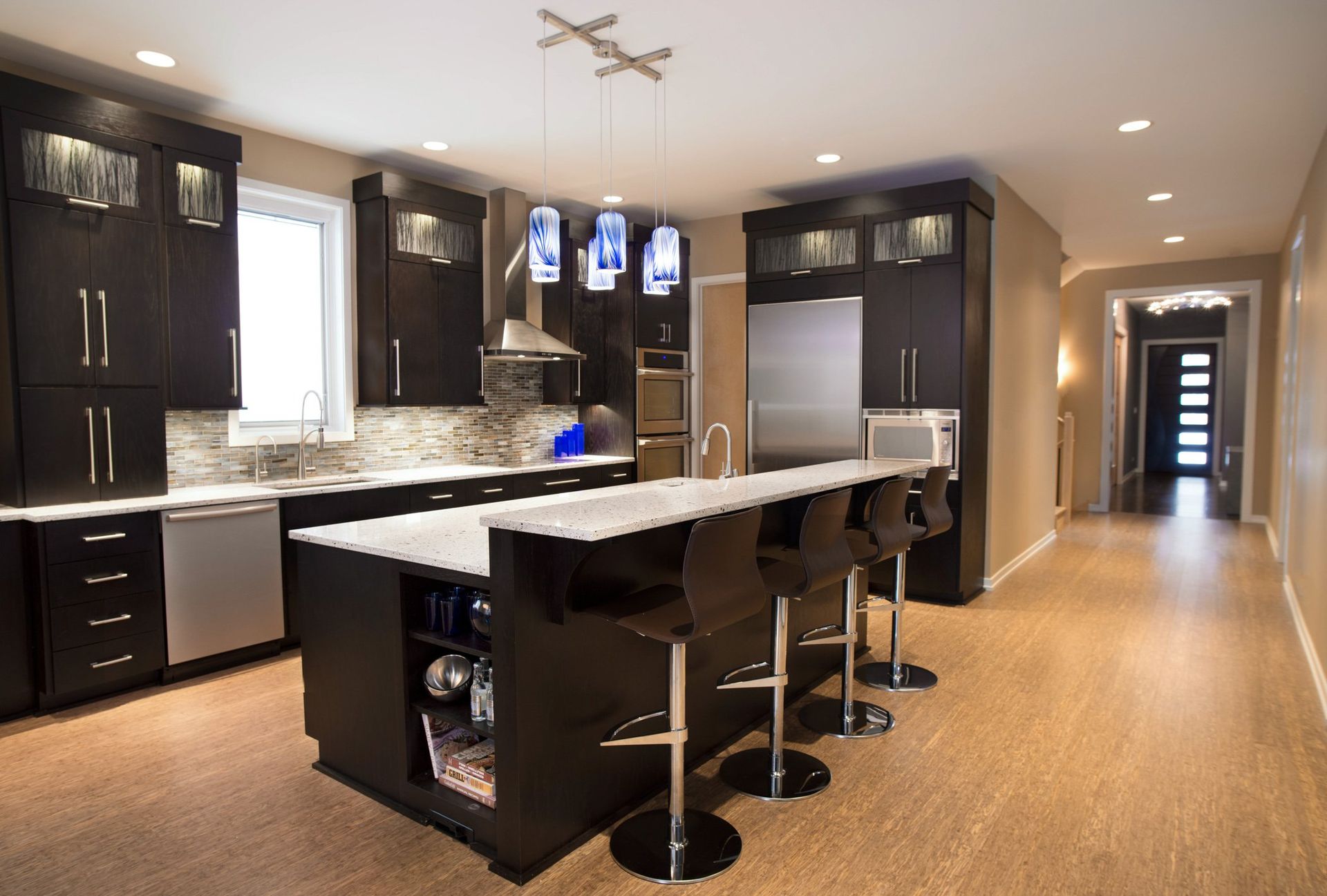 A kitchen with black cabinets and white counter tops