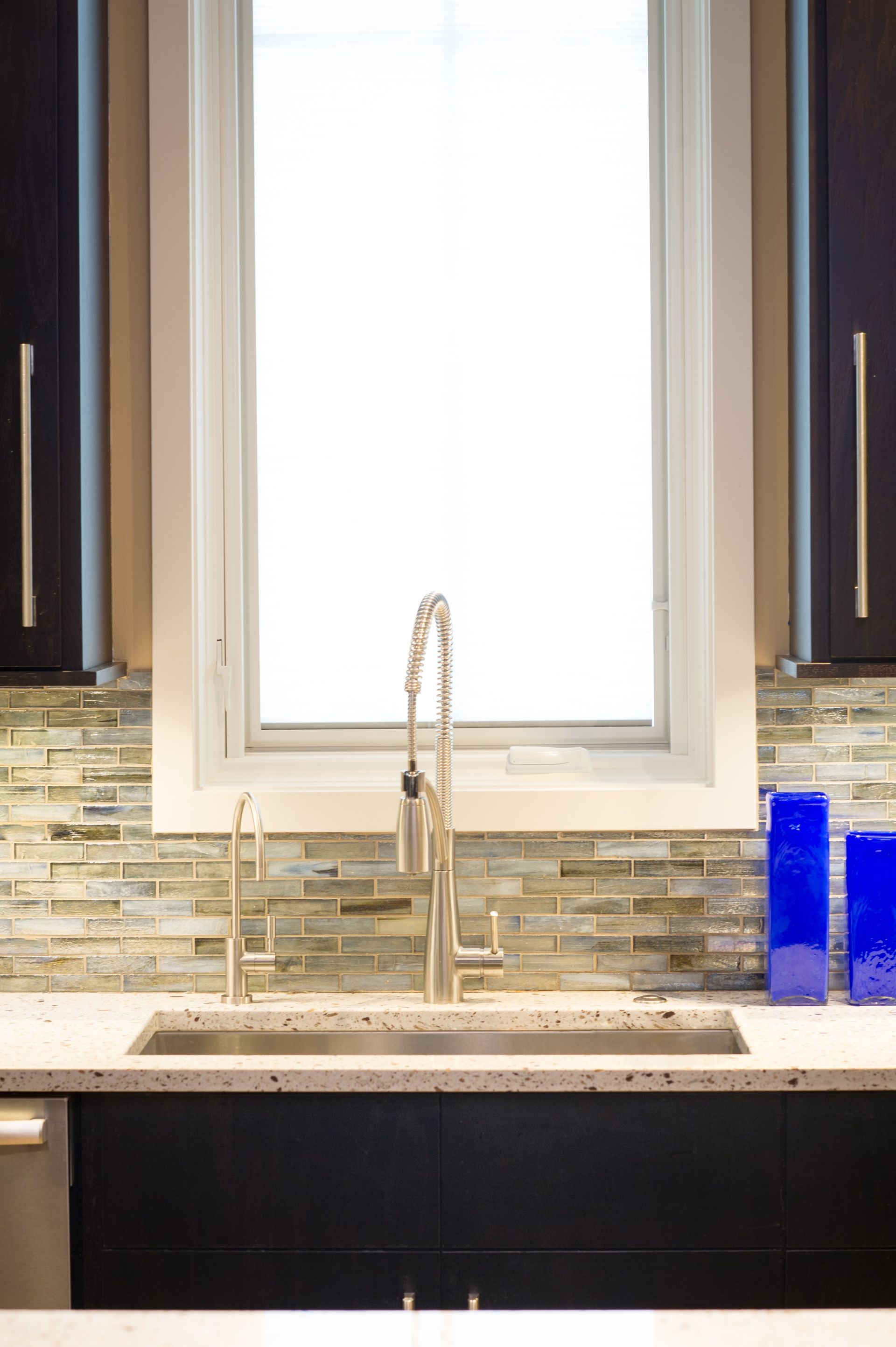 A kitchen sink with a window above it