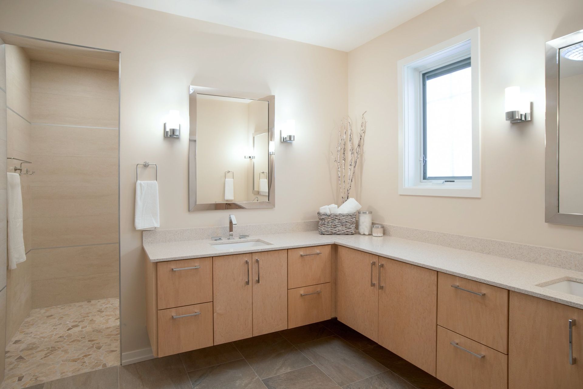 A bathroom with a sink , mirror and window