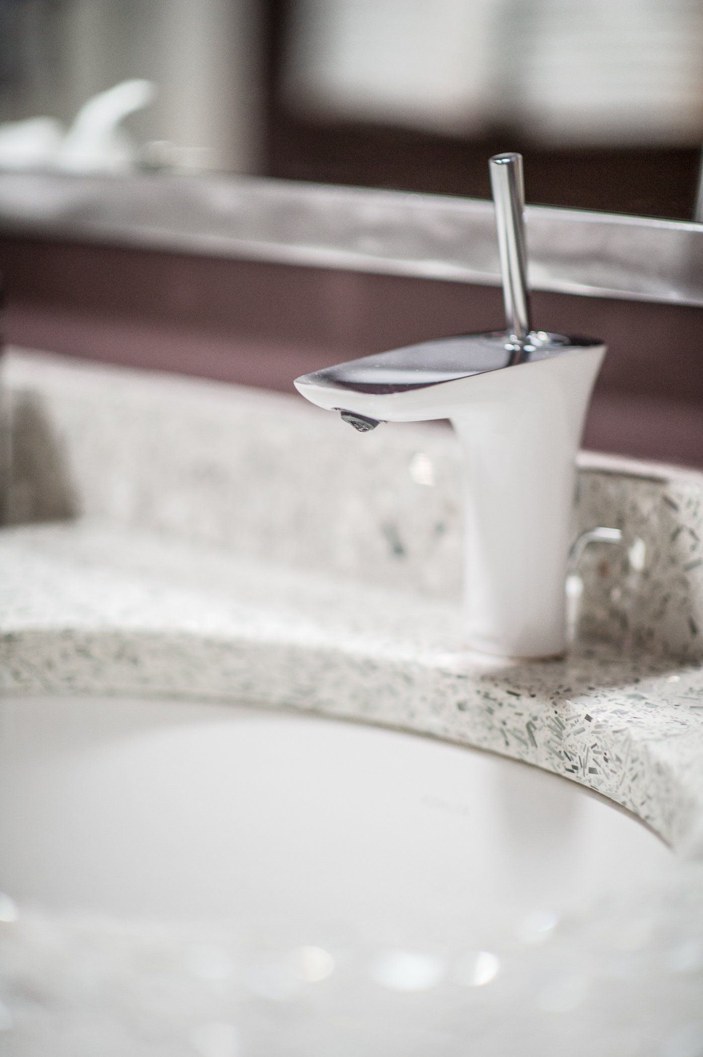 A close up of a bathroom sink with a faucet and a mirror.