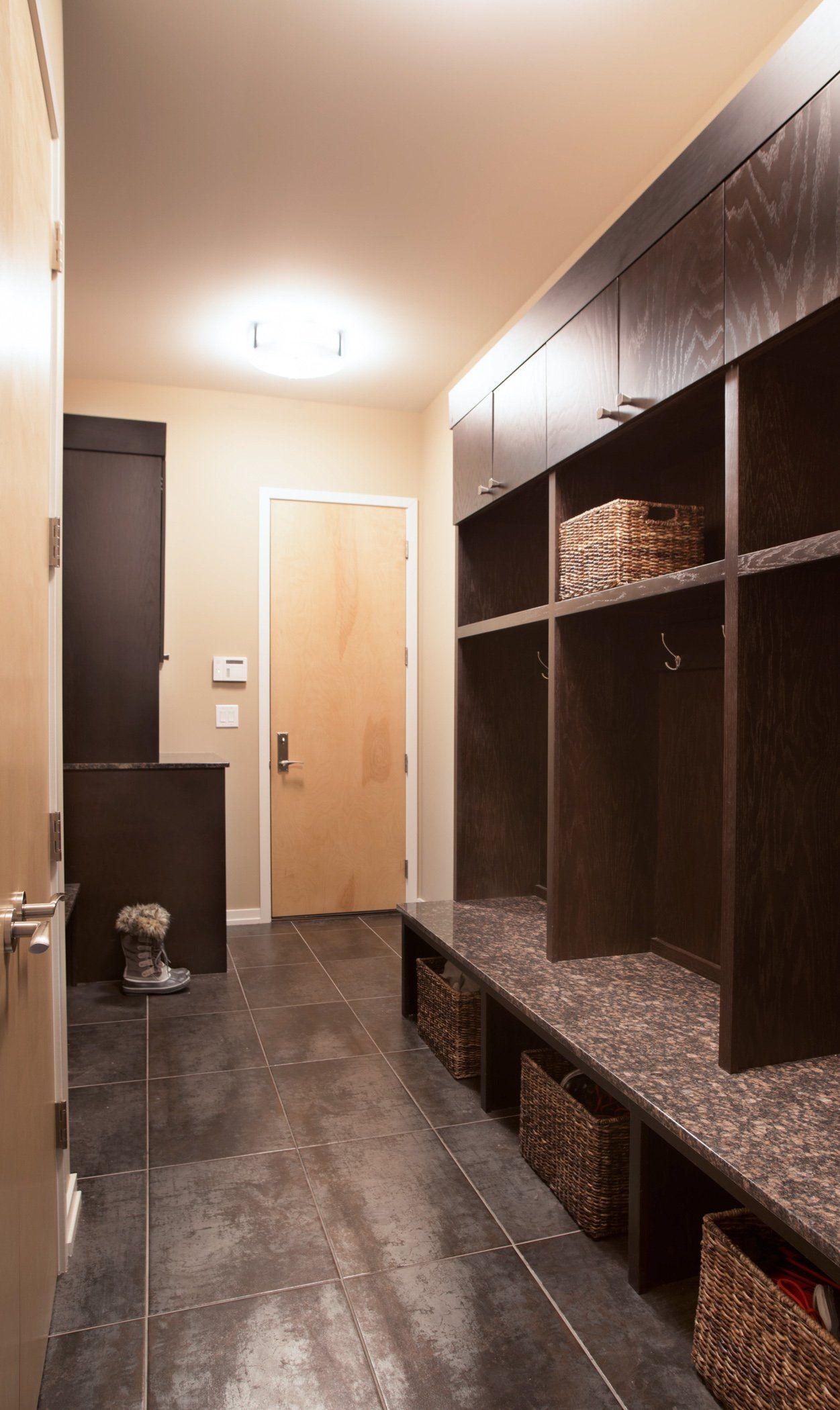A hallway with lots of shelves and baskets in it