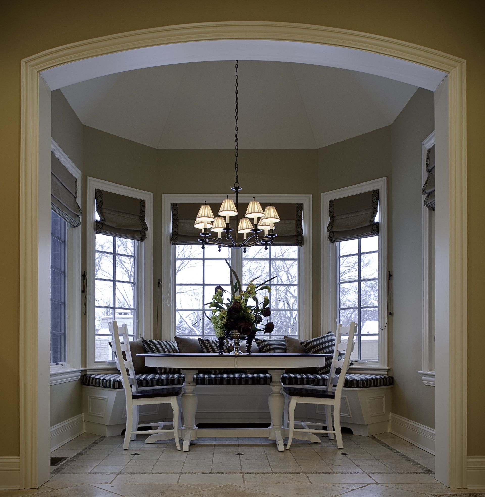 A dining room with a table and chairs and a chandelier