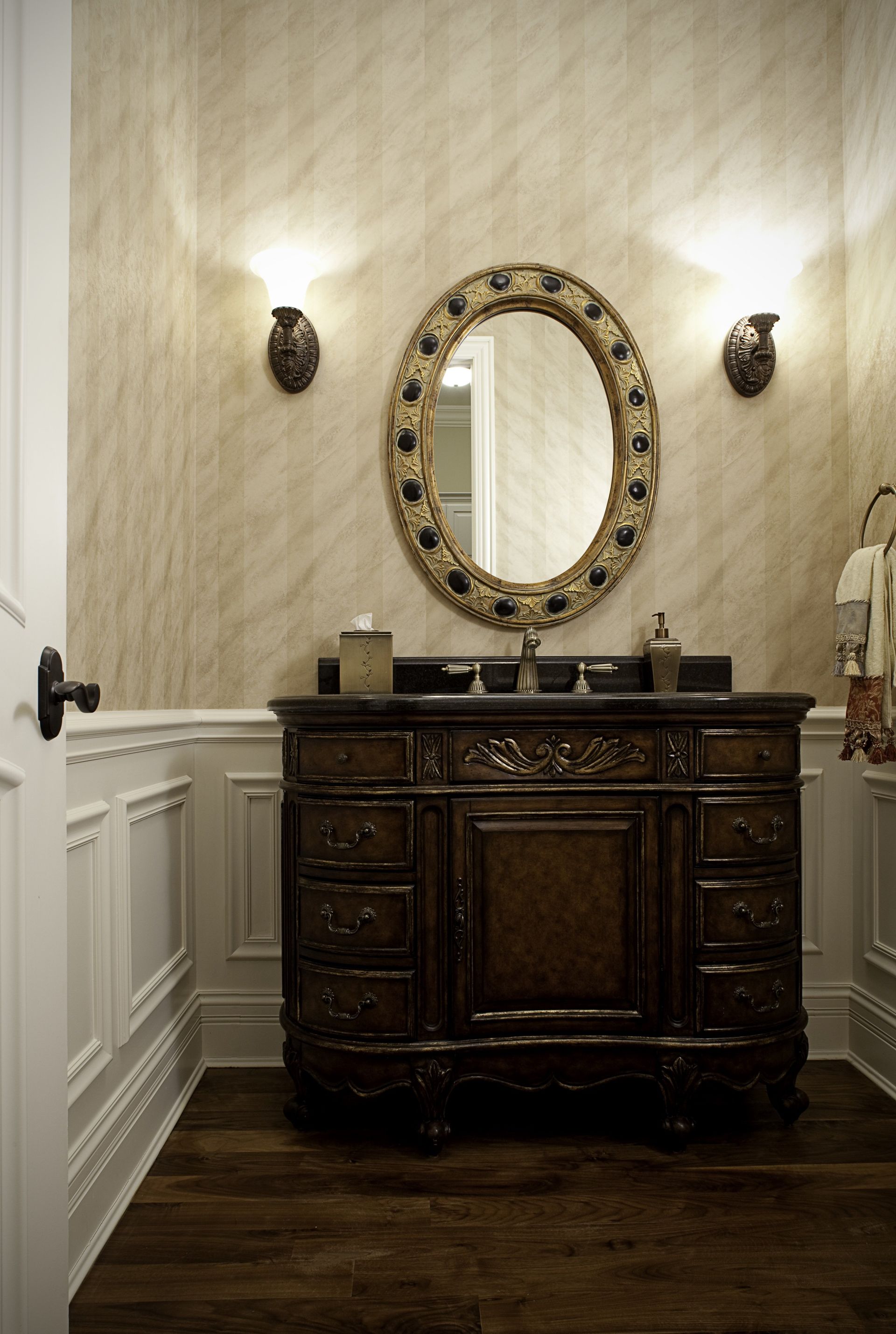 A bathroom with a vanity and a mirror on the wall