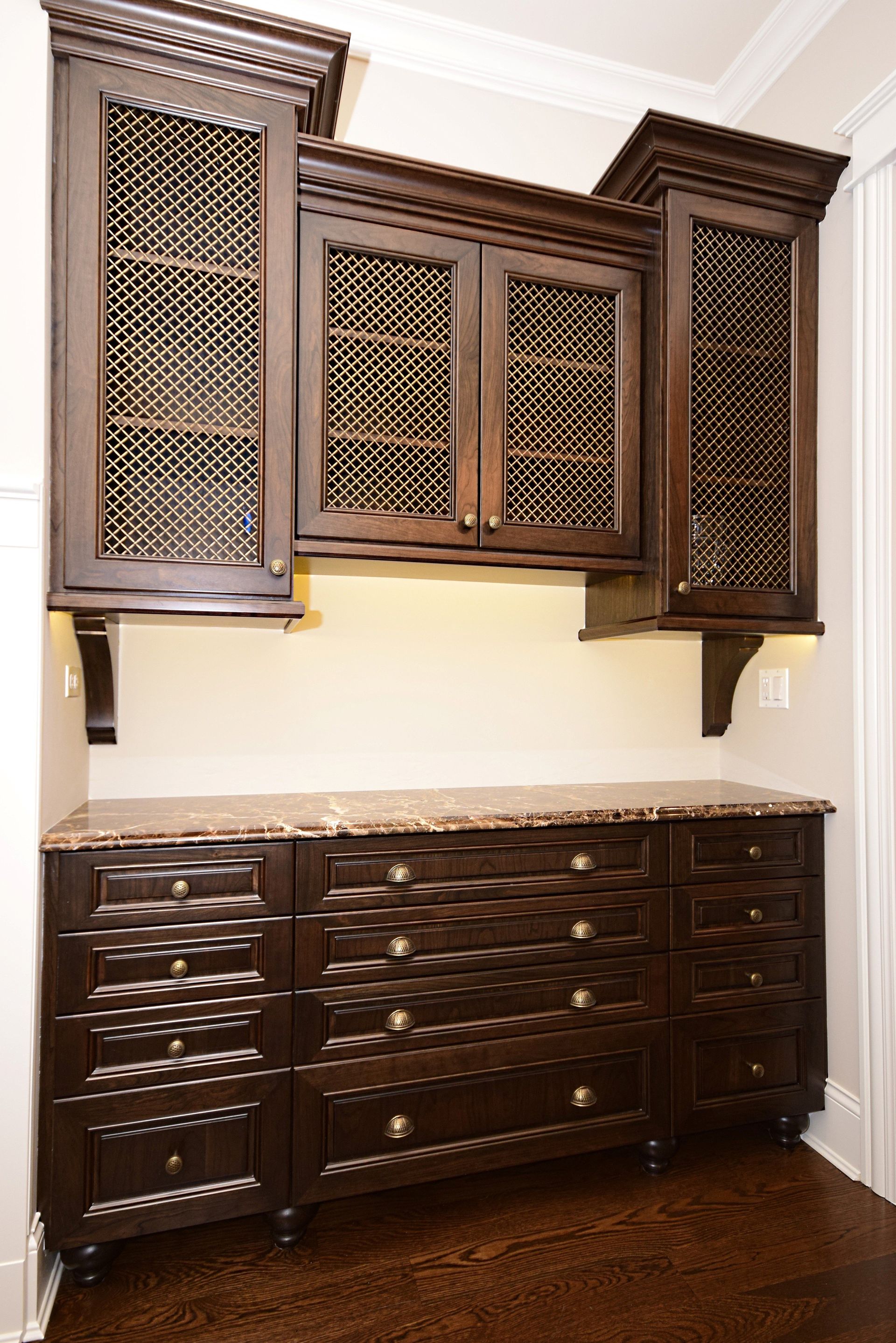 A kitchen with wooden cabinets and a wine rack.