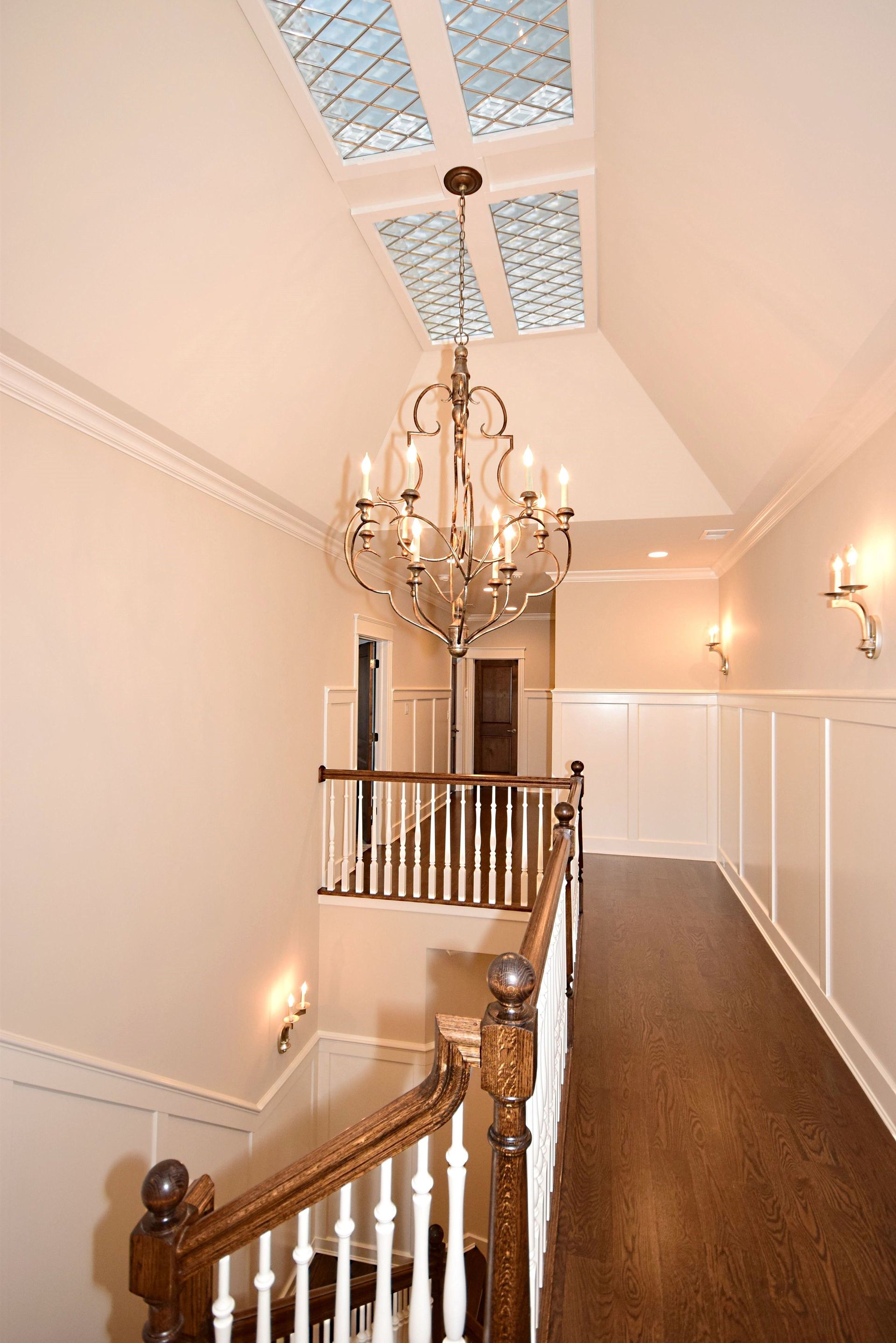 A staircase with a chandelier hanging from the ceiling