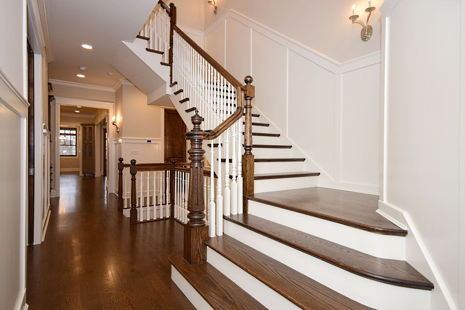 A hallway with stairs leading up to the second floor