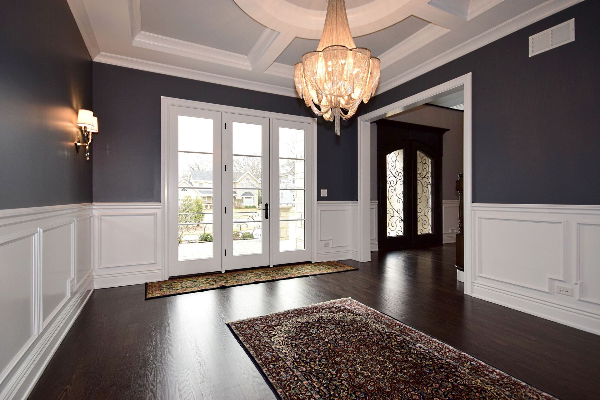 An empty hallway with a chandelier hanging from the ceiling