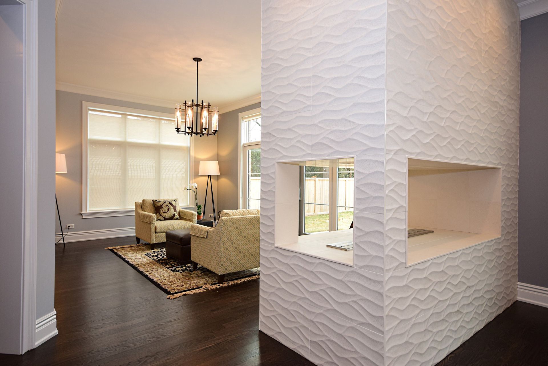 There is a fireplace in the middle of the living room.