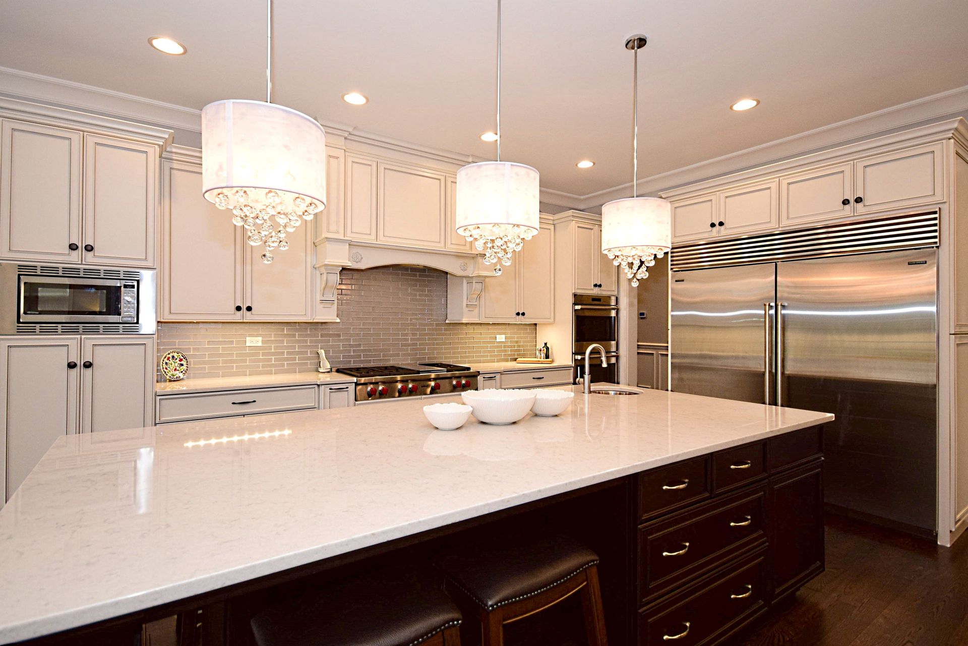 A kitchen with white cabinets and stainless steel appliances