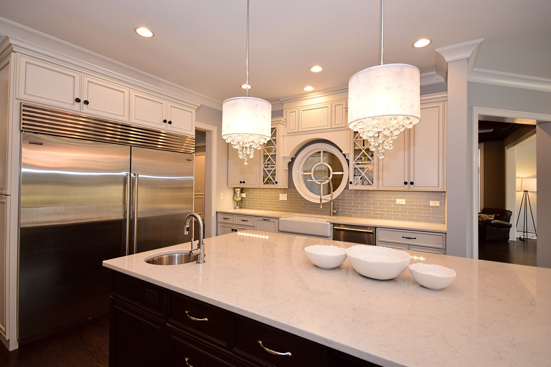 A kitchen with white cabinets and stainless steel appliances