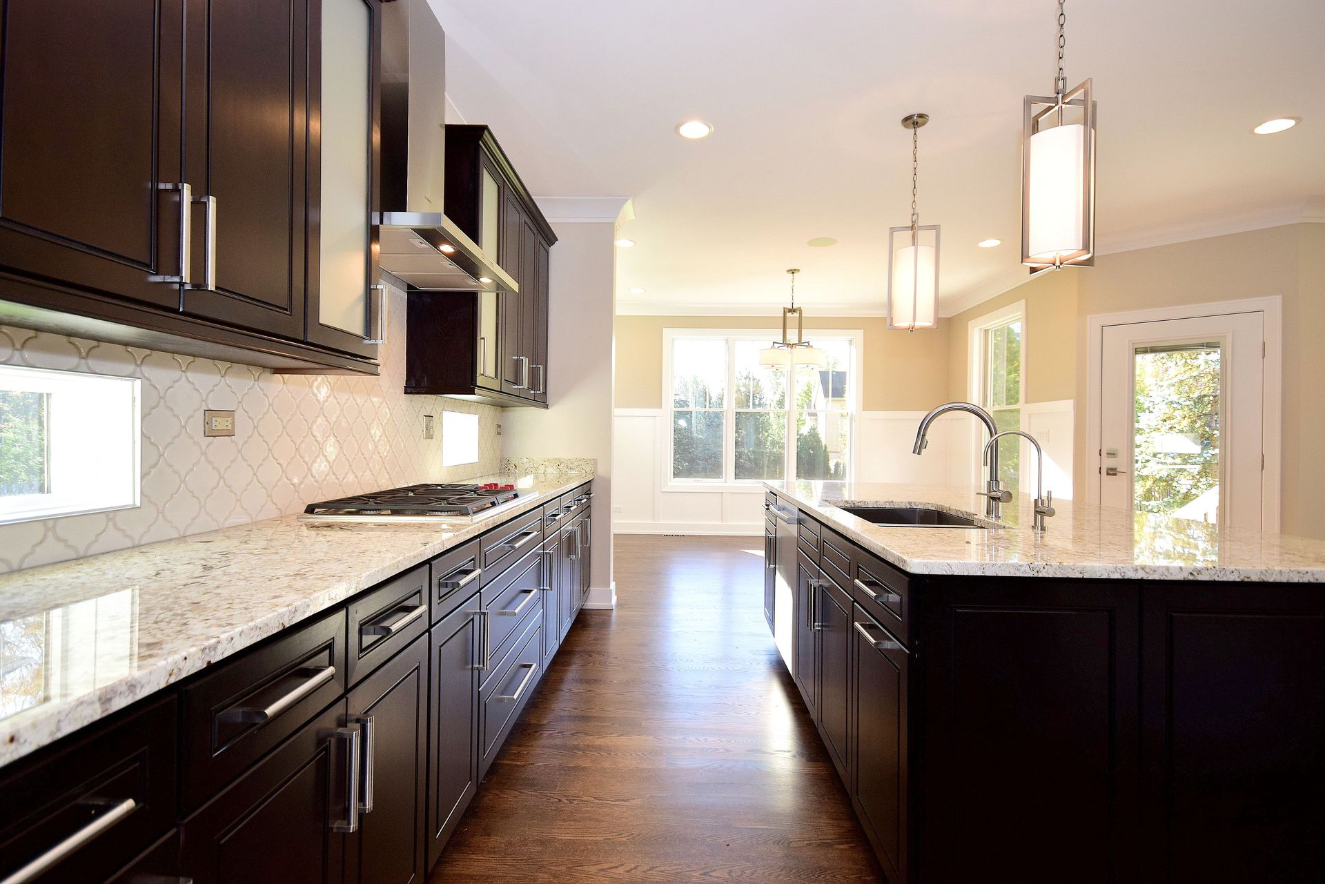 A kitchen with black cabinets and granite counter tops