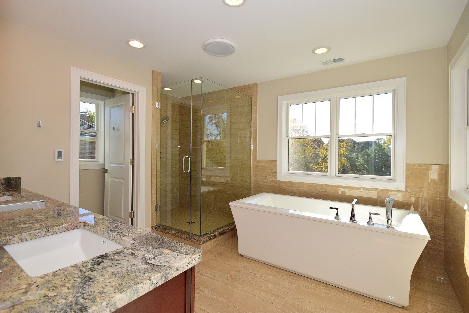 A bathroom with a tub , sink , and shower.