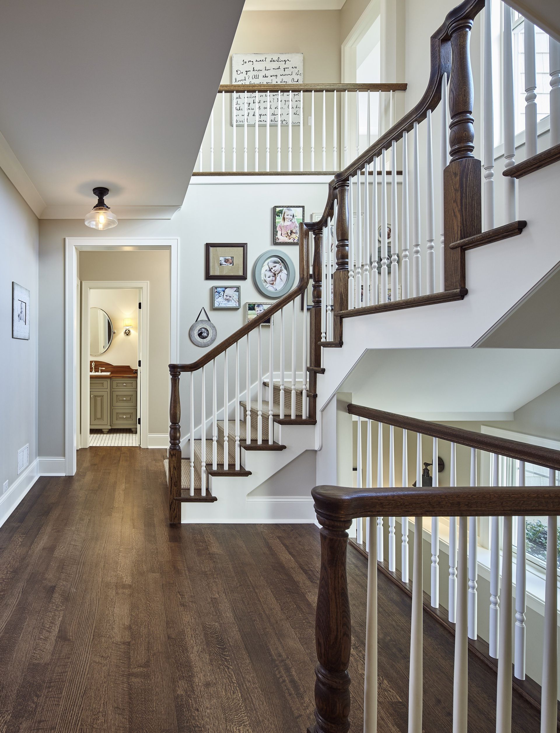 A hallway with stairs leading up to the second floor of a house