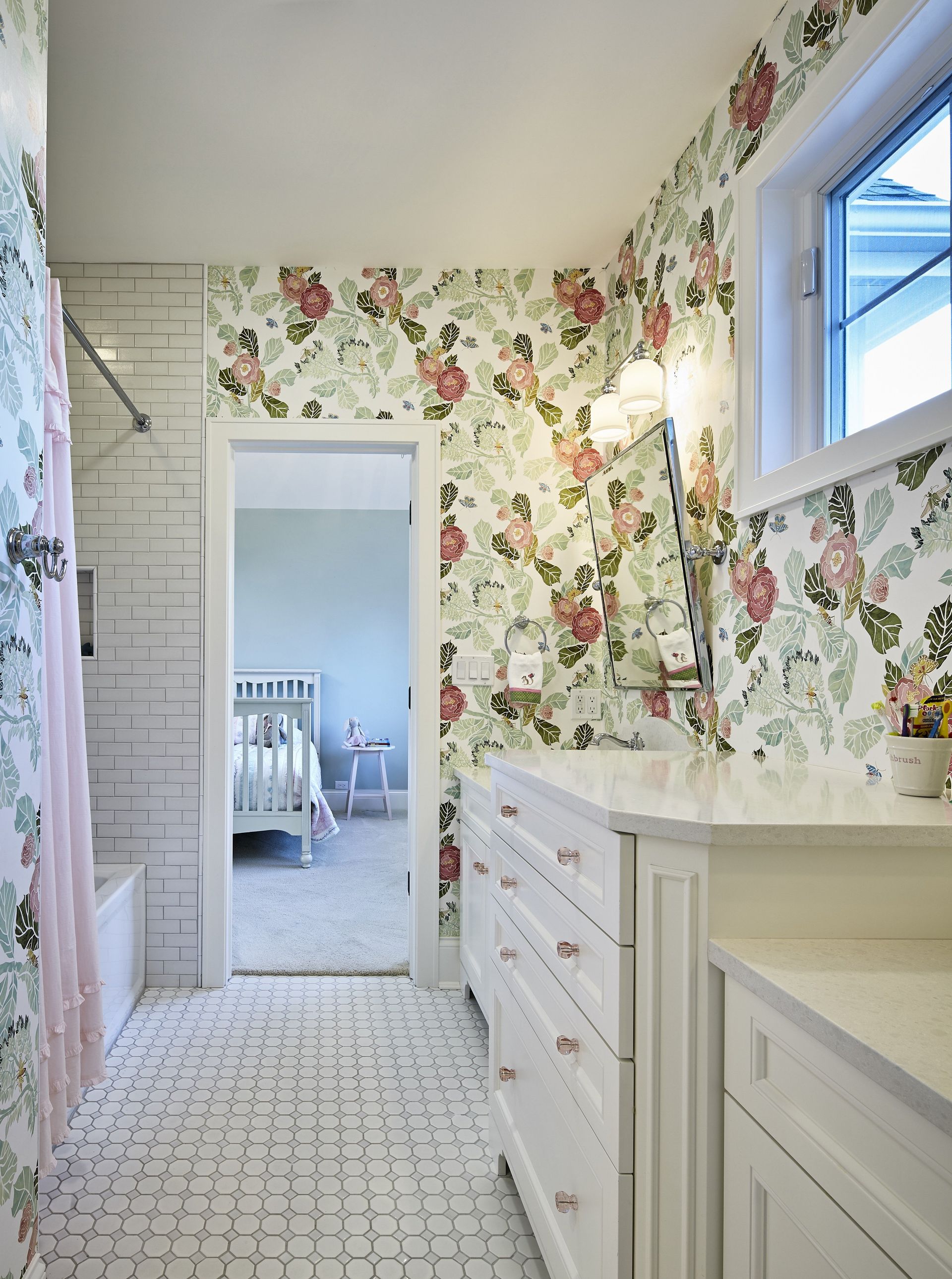 A bathroom with floral wallpaper on the walls