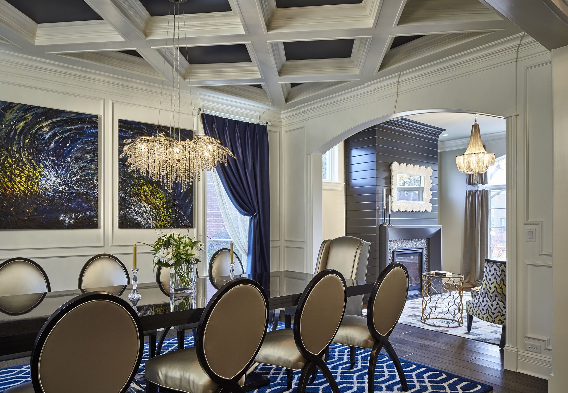 A dining room with a table and chairs and a chandelier