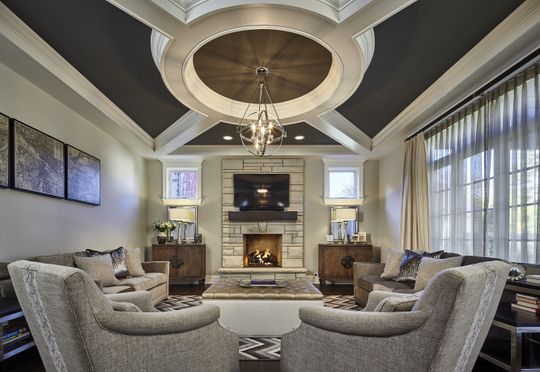 A living room with a fireplace and a chandelier