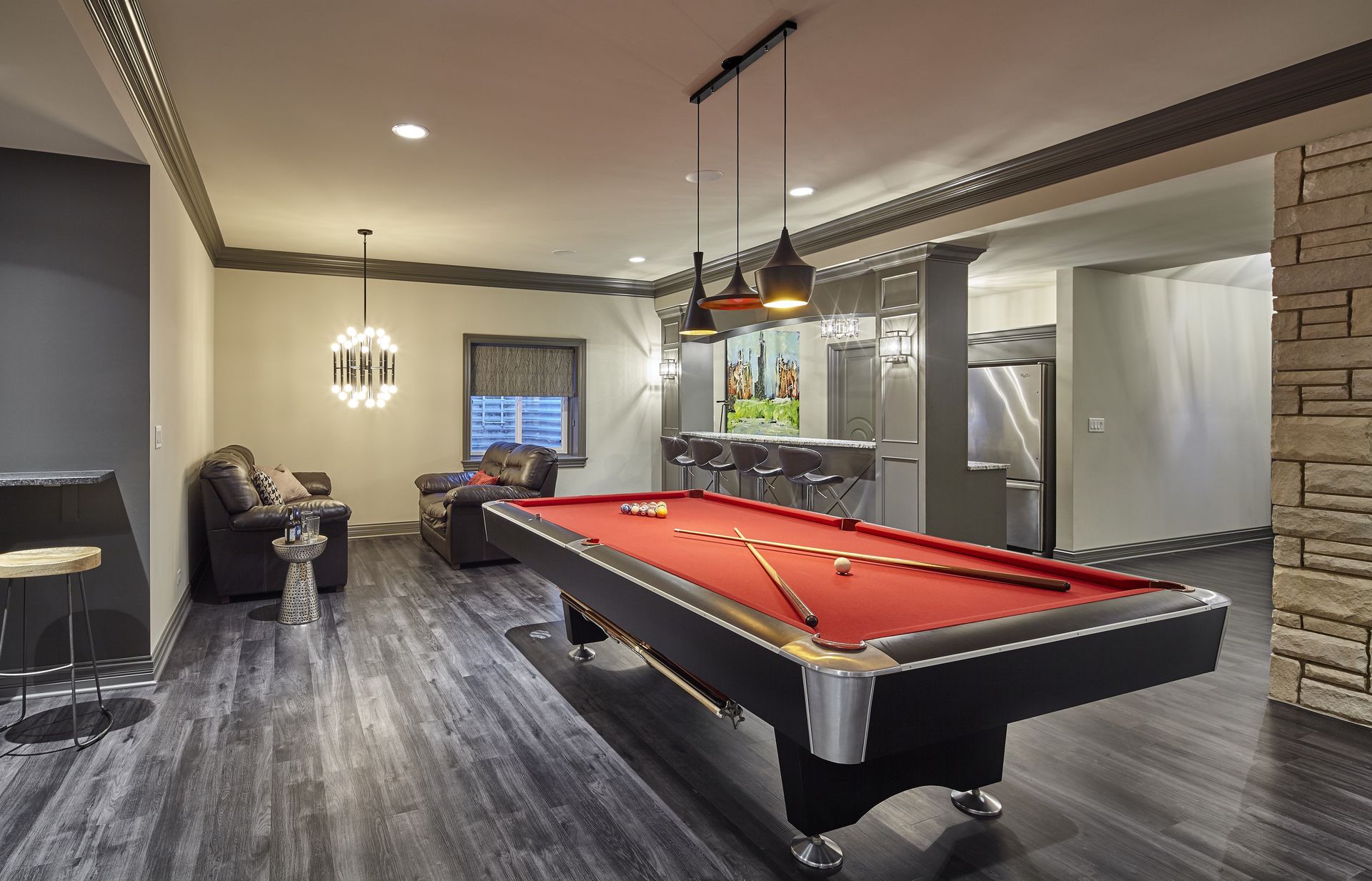 There is a pool table in the middle of the room.