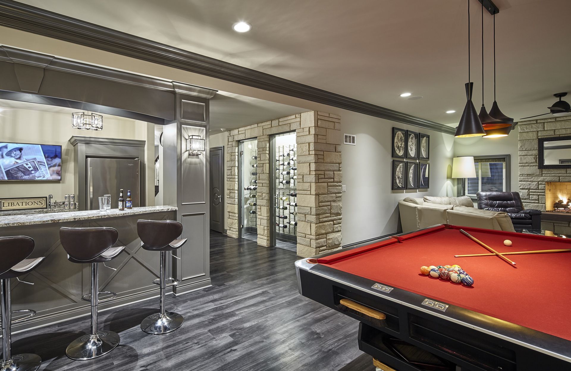 A pool table is in the middle of a living room