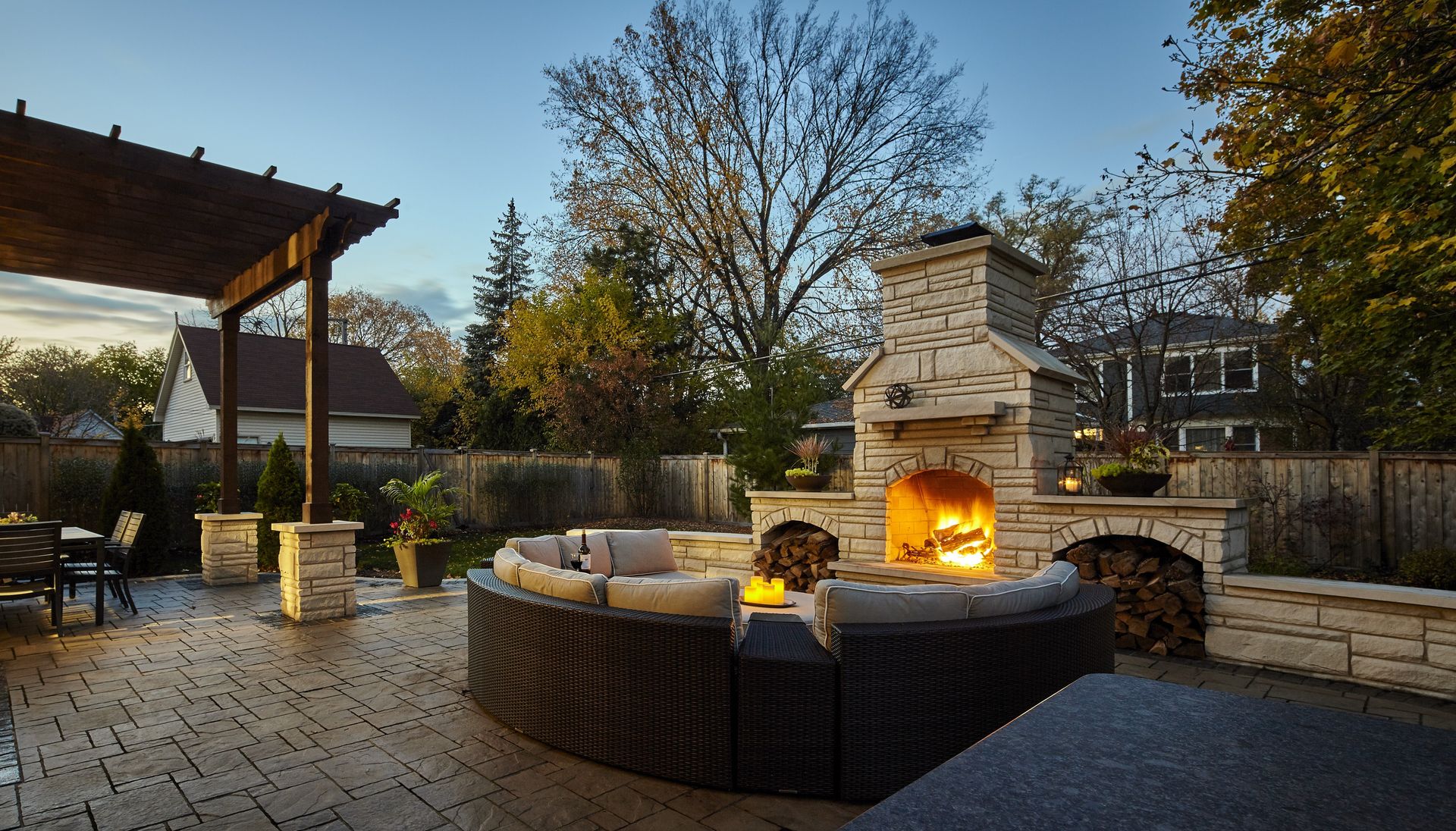 A patio with a fireplace and a couch in the middle