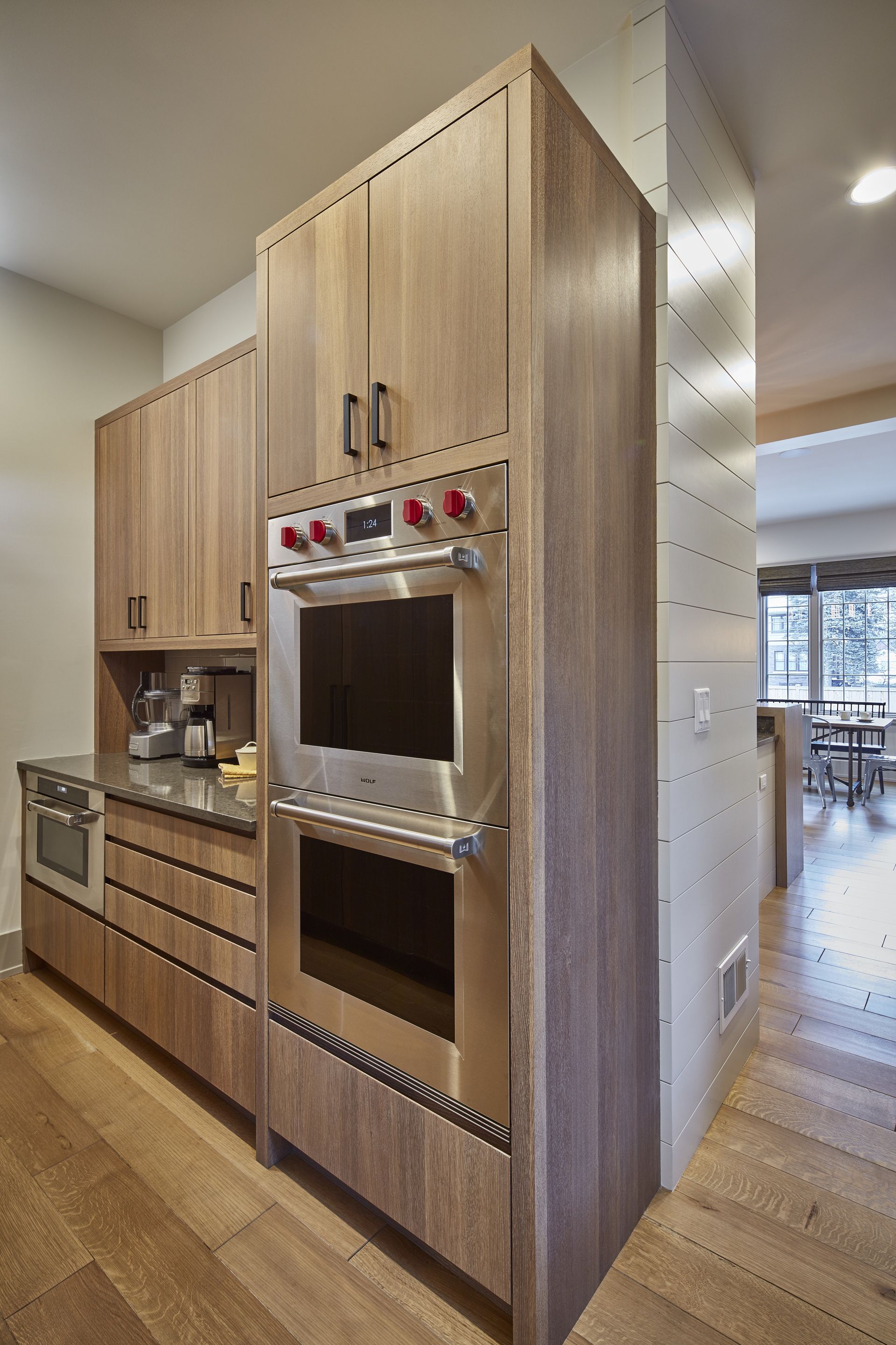 A kitchen with stainless steel appliances and wooden cabinets.