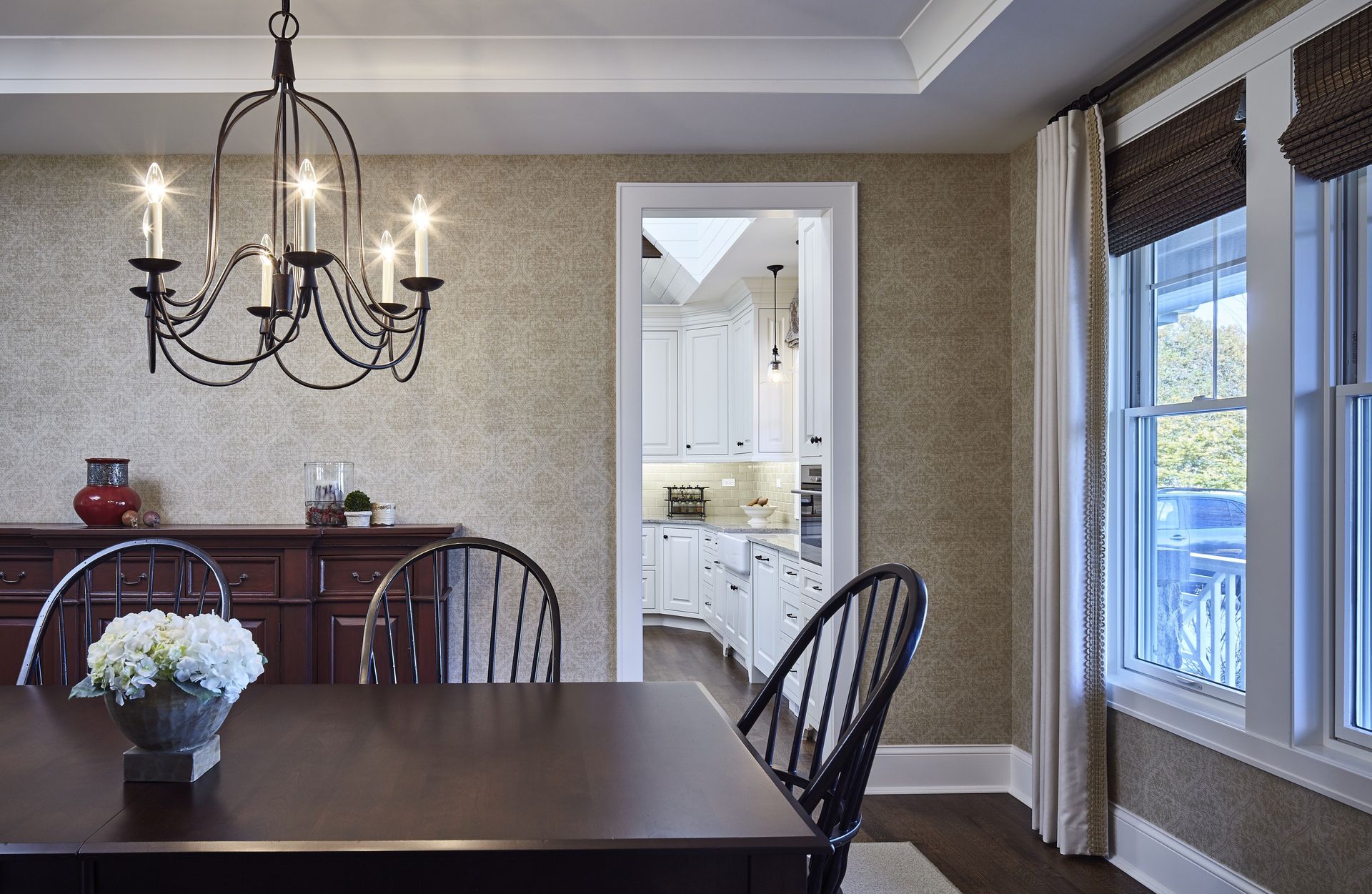 A dining room with a table and chairs and a chandelier