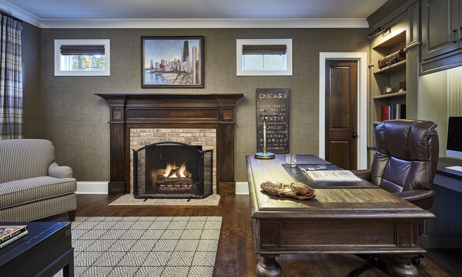 A living room with a fireplace and a desk