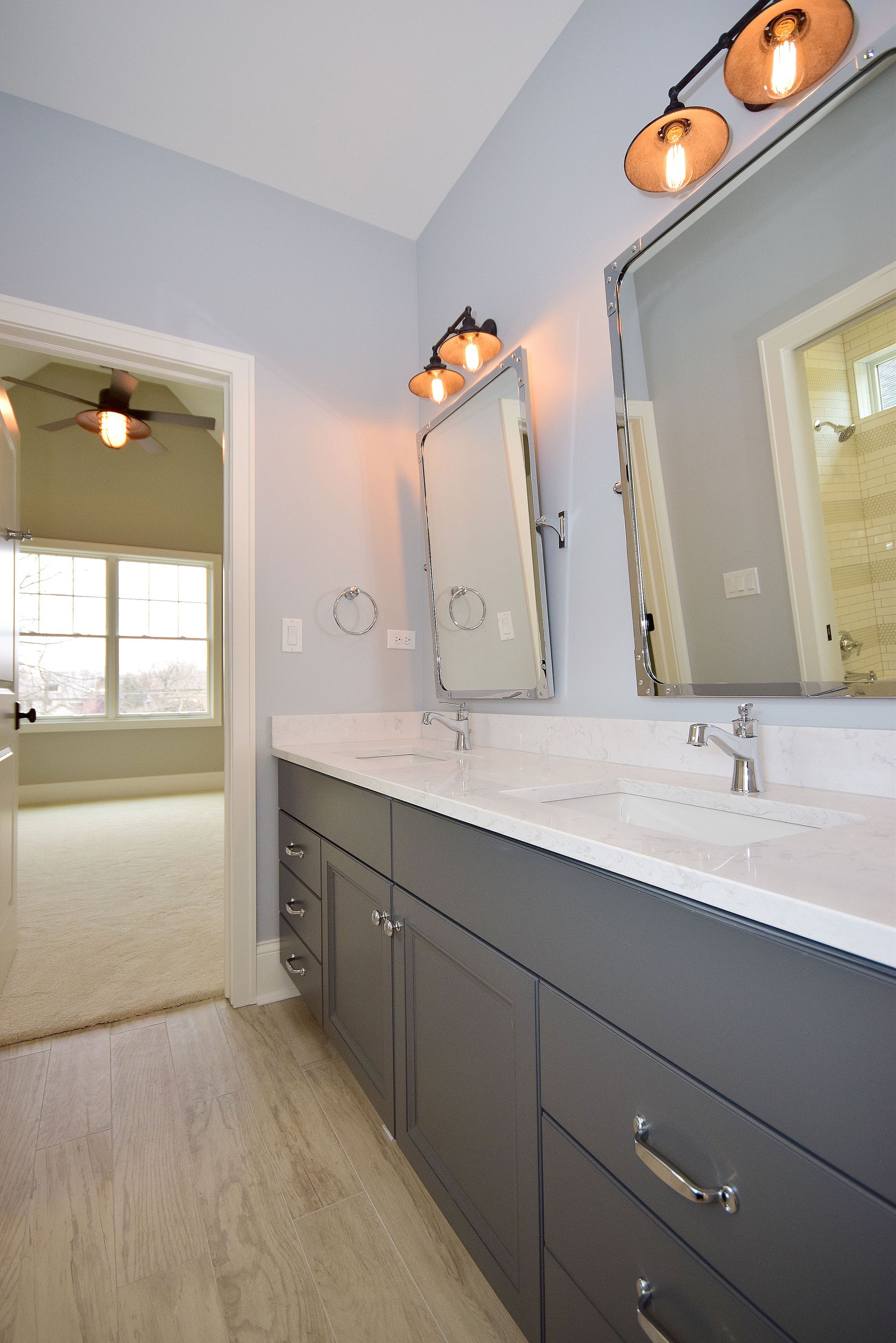 A bathroom with two sinks and two mirrors.