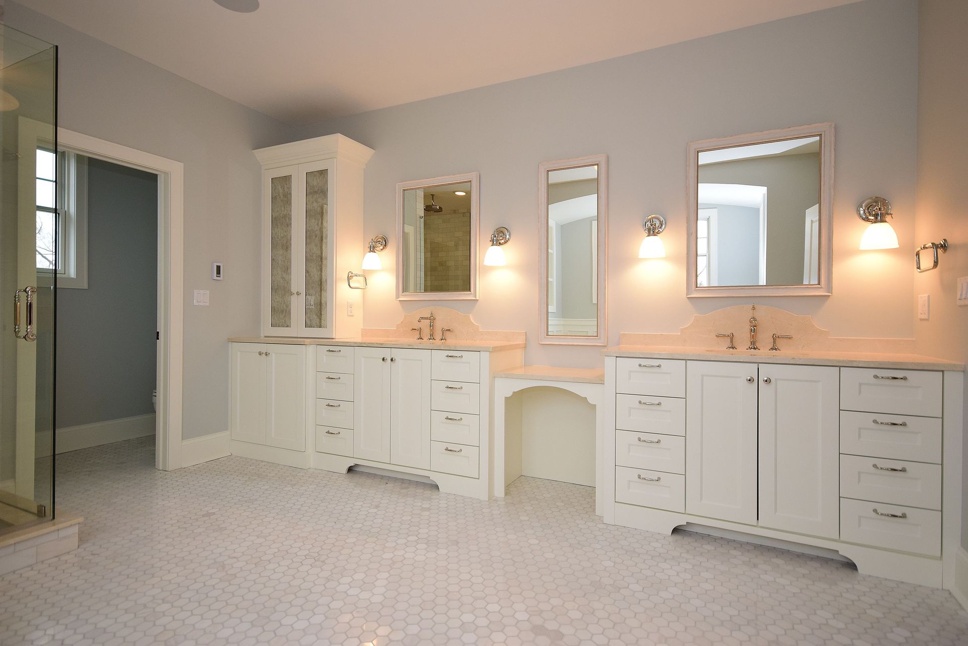 A bathroom with two sinks and two mirrors