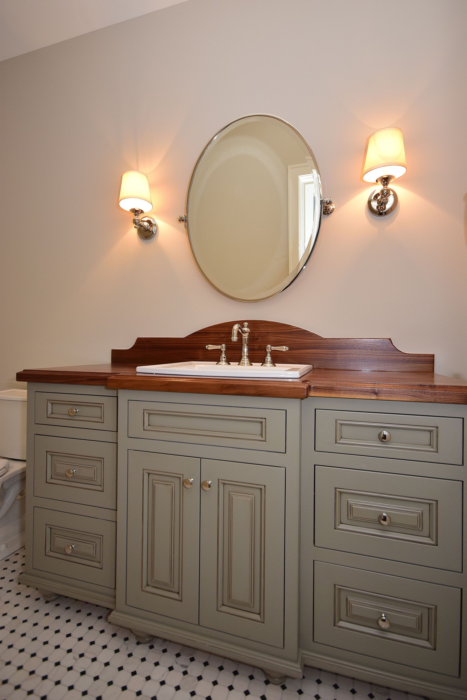 A bathroom with a sink and a mirror on the wall
