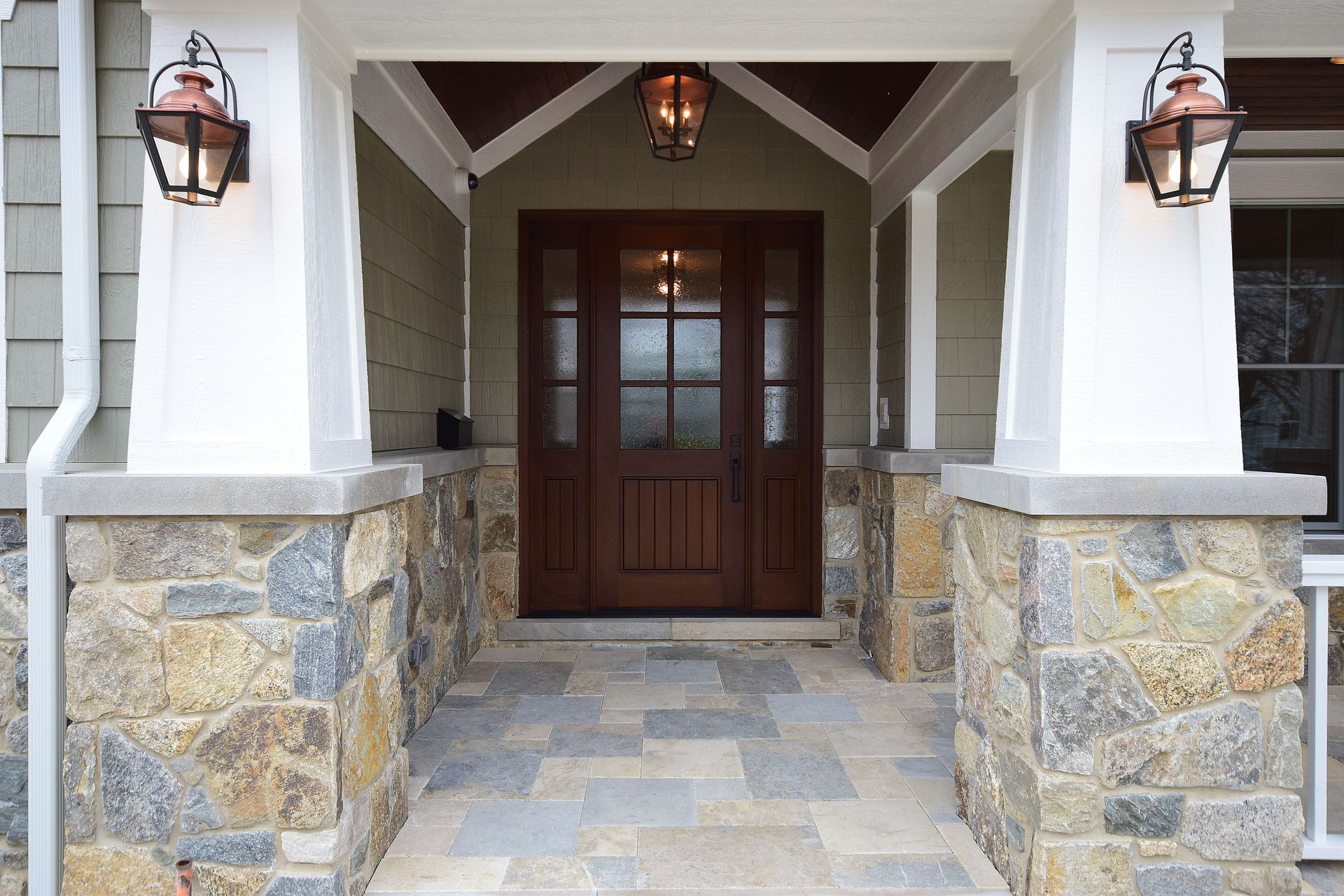 The front door of a house with a stone walkway leading to it.