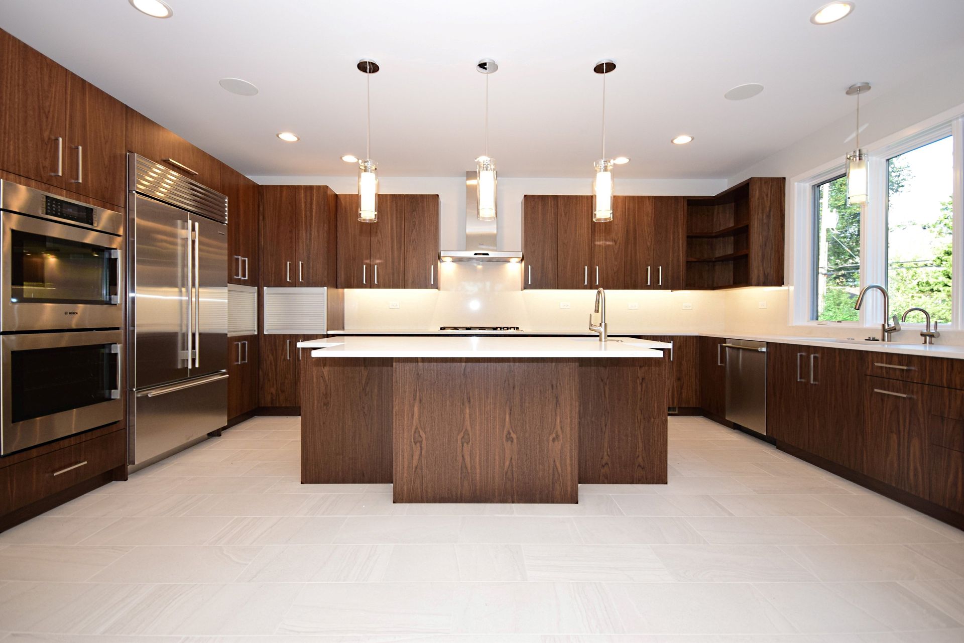 A kitchen with stainless steel appliances and wooden cabinets